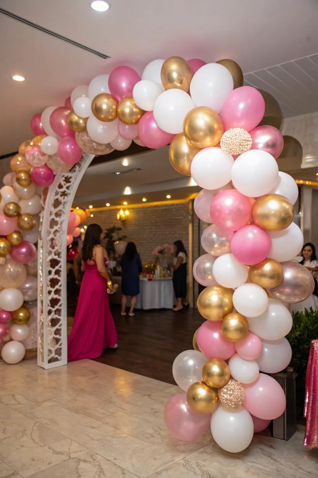 A stunning balloon arch in metallic pink, gold, and white.