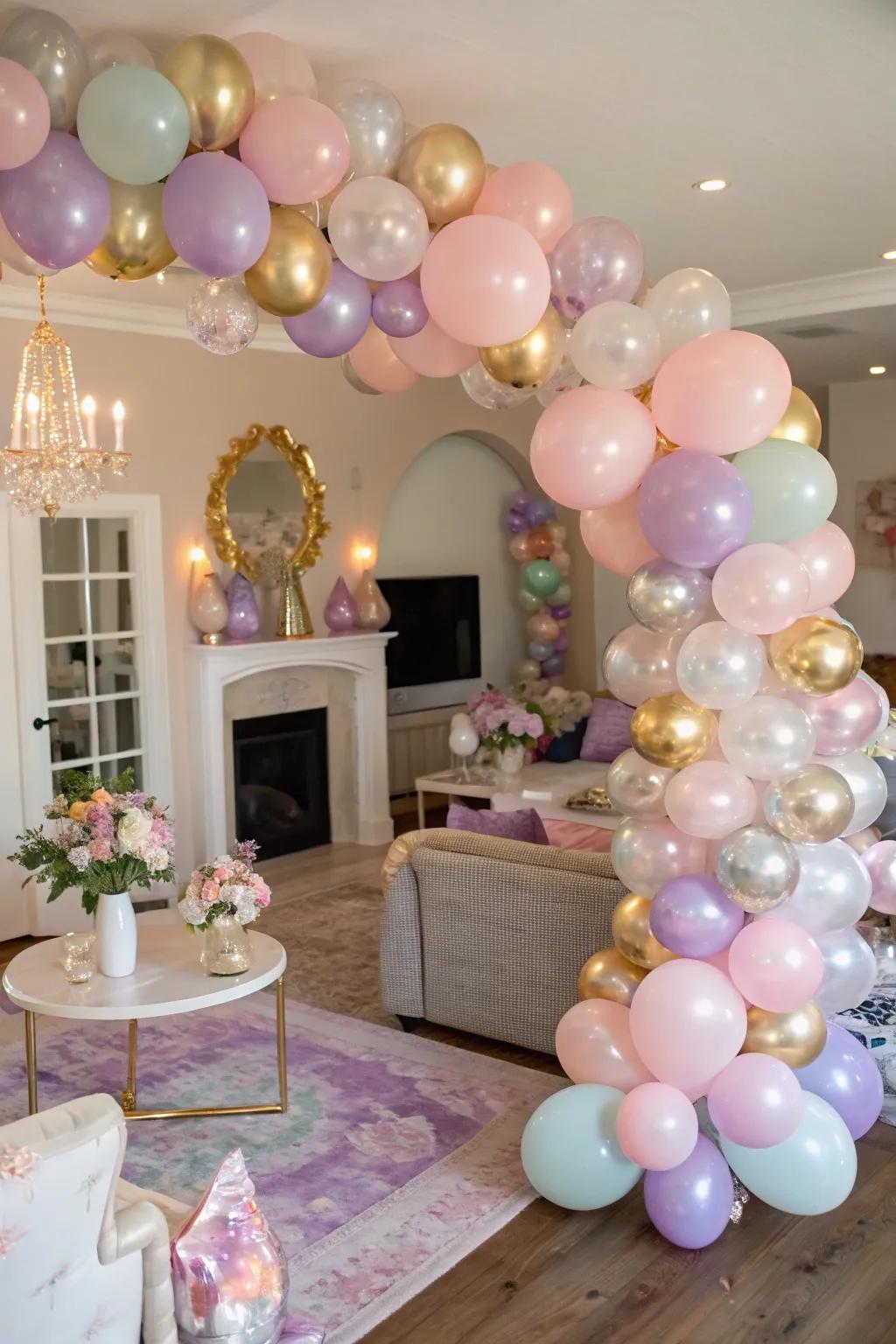 A welcoming room brightened by an elegant balloon arch in tones of pastel and shining metallics.