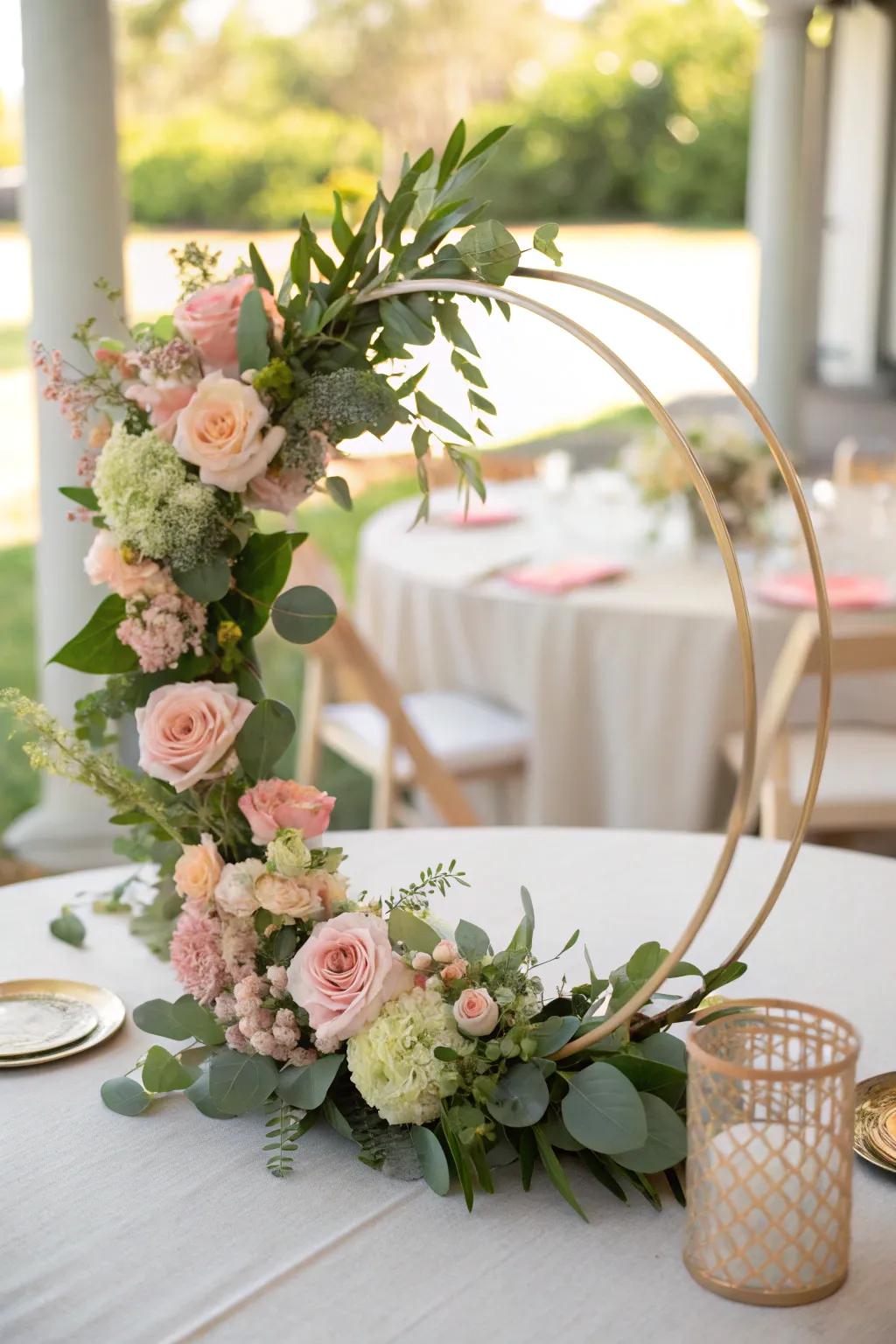 Elegant floral hoop centerpiece featuring pastel blooms.