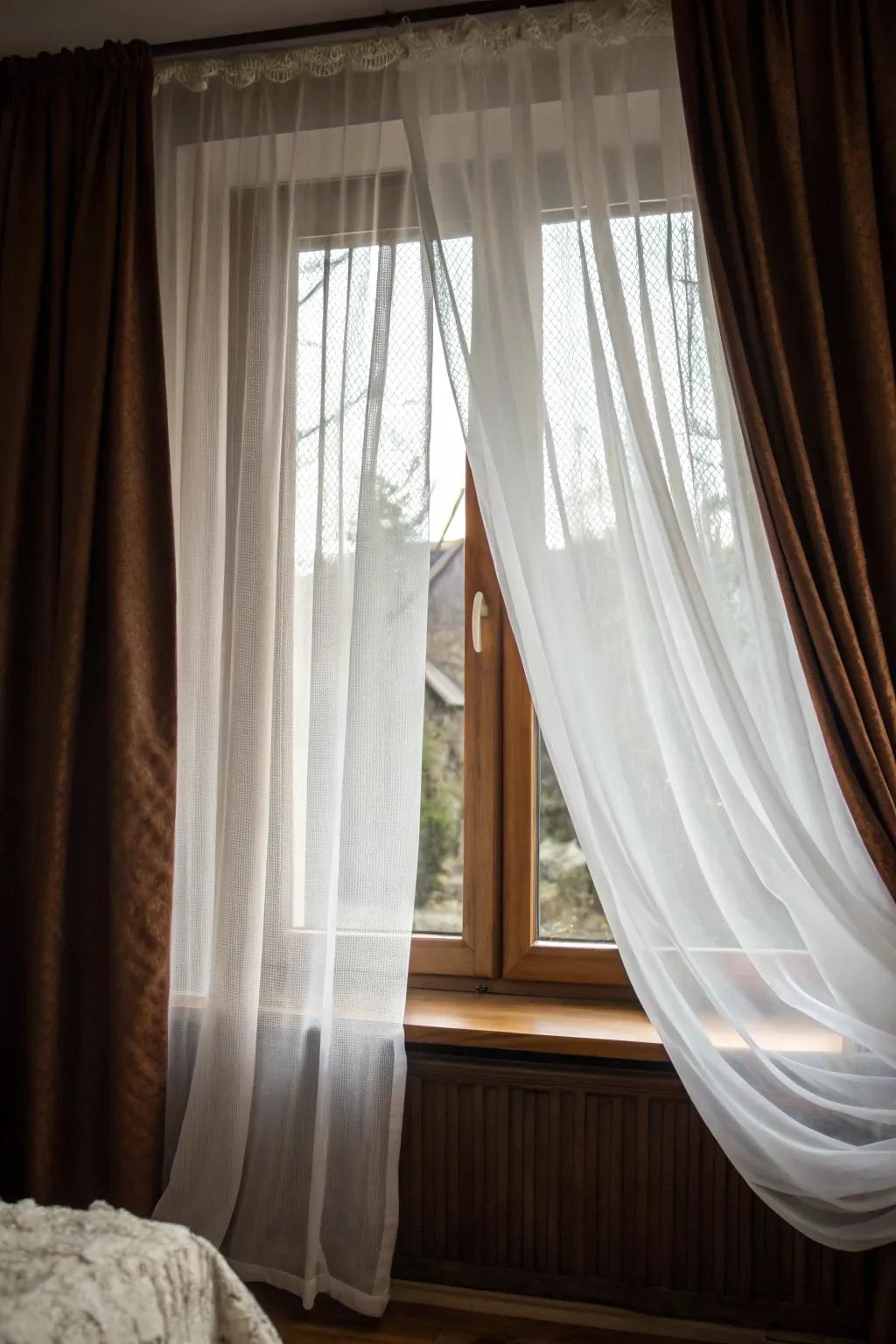 Sheer and opaque curtains beautifully layered for a cozy, private bedroom feel.