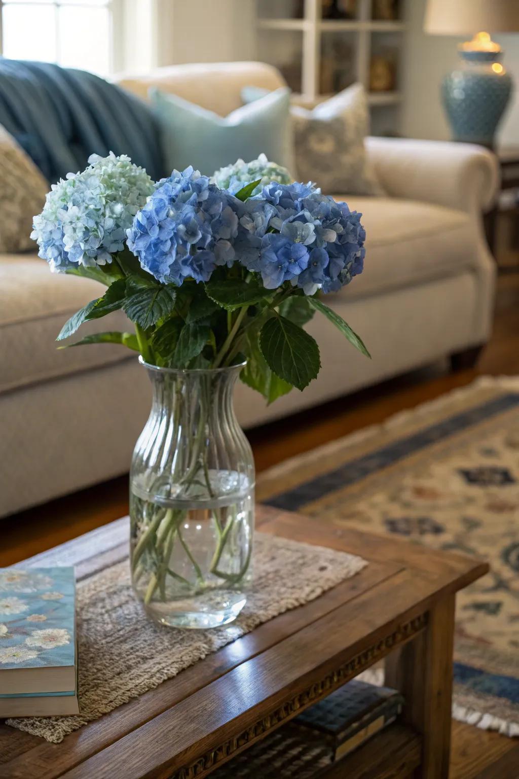 A glass vase with blue hydrangeas introduces a burst of vibrancy to a snug living area.