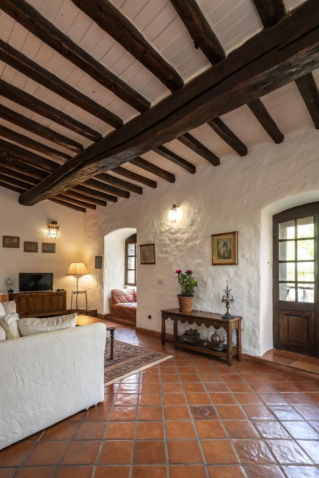 Exposed wooden beams bring a rustic elegance to this Spanish-inspired living space.