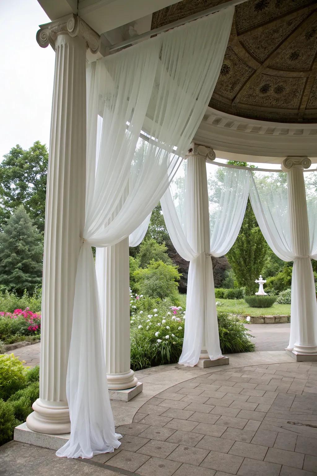 Flowing white voile drapery establishes a romantic setting for the wedding.