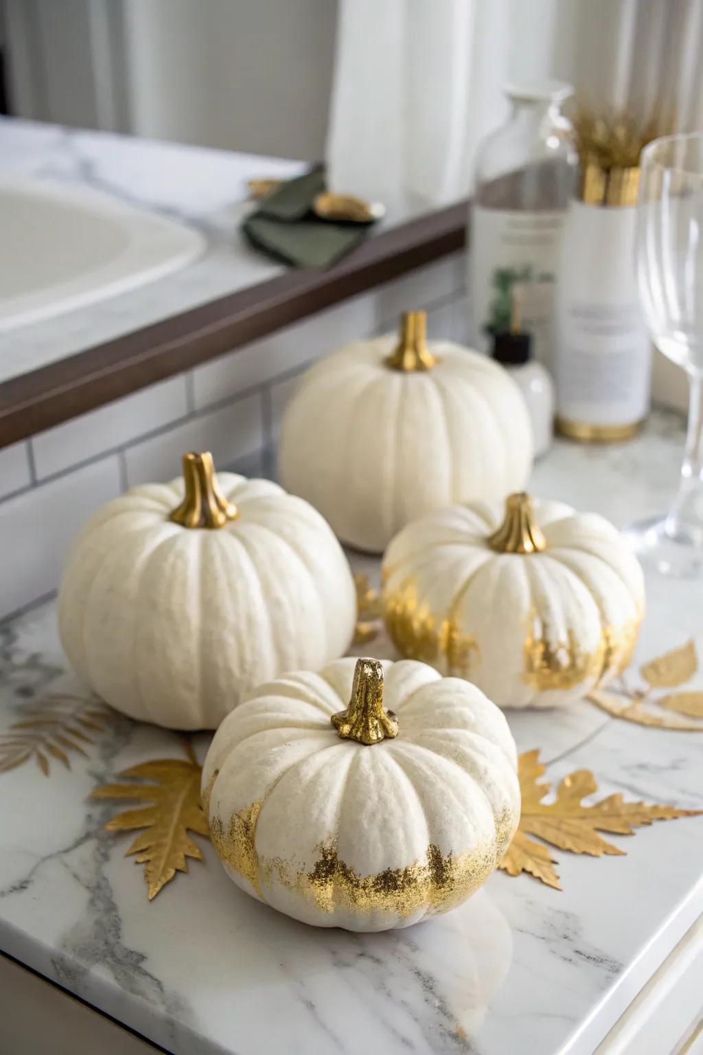 White pumpkins accented with gold for an upscale atmosphere.