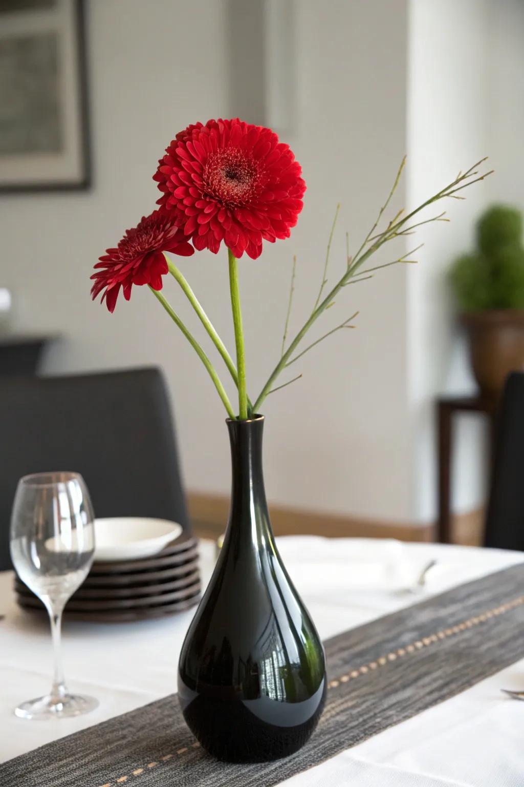 A solitary scarlet bloom in an obsidian vase for an unpretentious and striking centerpiece.