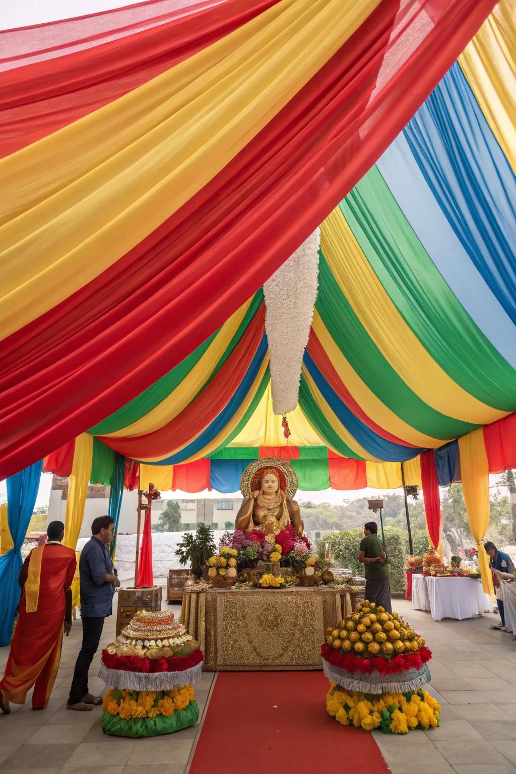 Dramatic and colorful drapes constructing a canopy over the Ganesh Chaturthi arrangement.
