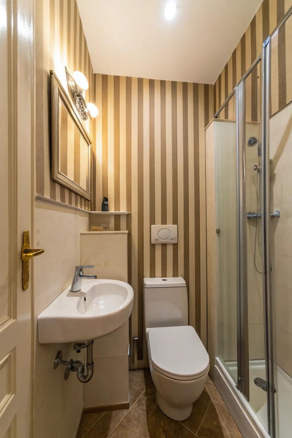 Vertical lineation augments the perceived height of this compact bathroom.