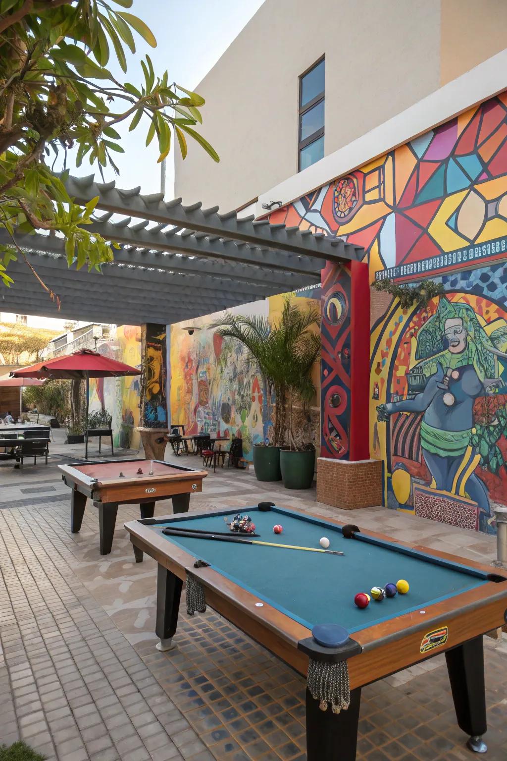 A creative outdoor pool table area with wall art and sculptures.