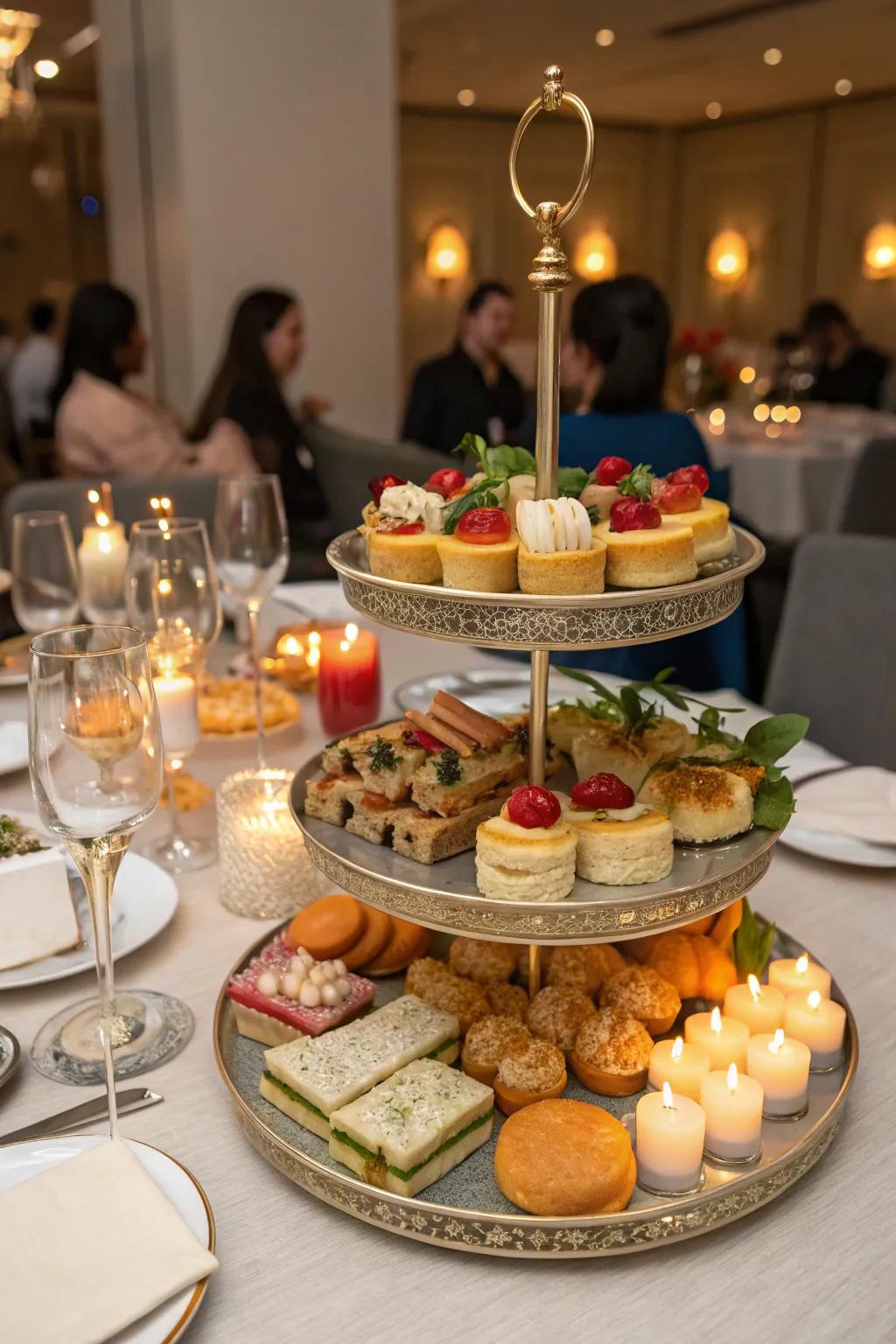 A dining table ready for a party, featuring a tiered tray stocked with tempting snacks.