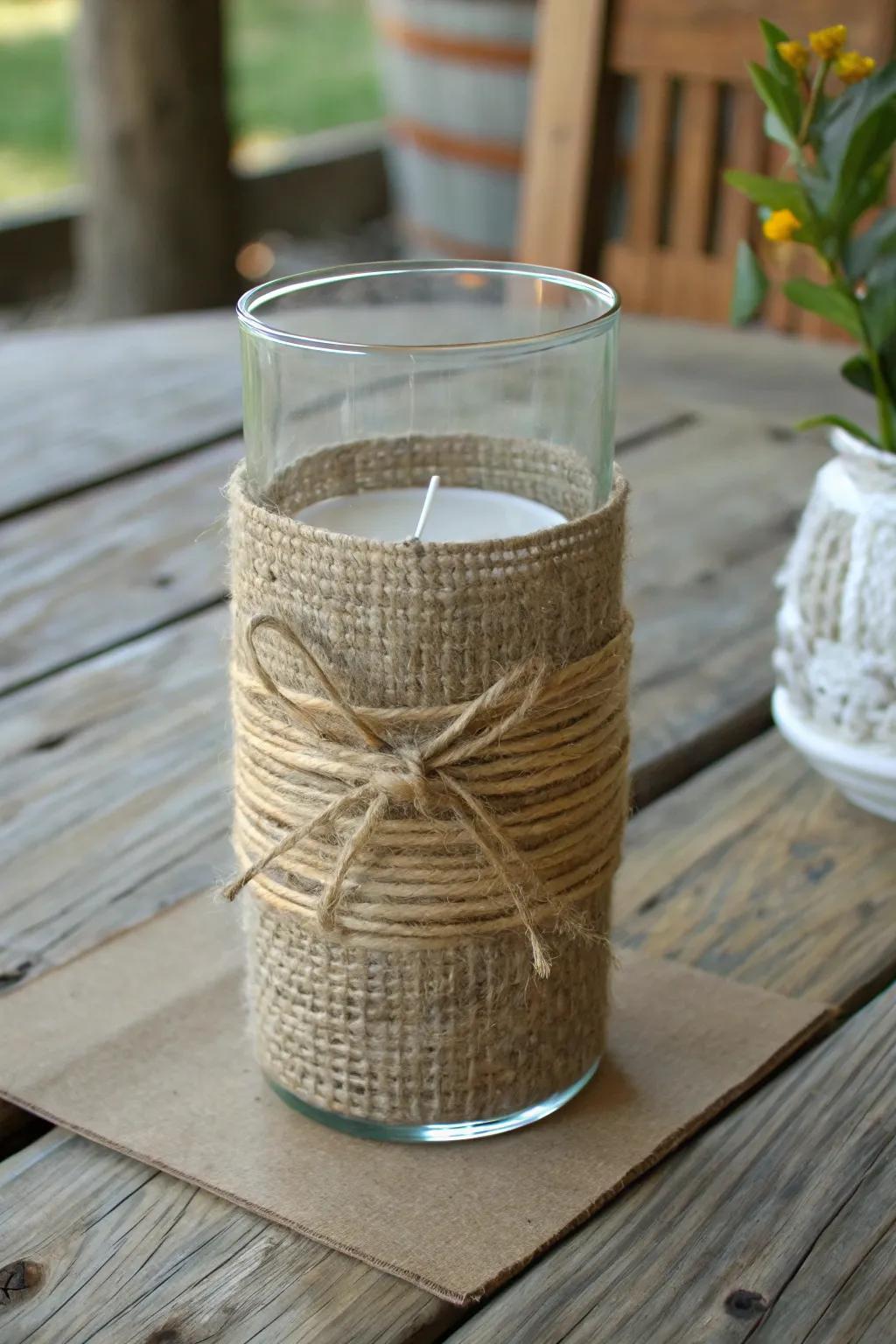Twine and burlap wrapped around a hurricane vase for a touch of rustic charm.