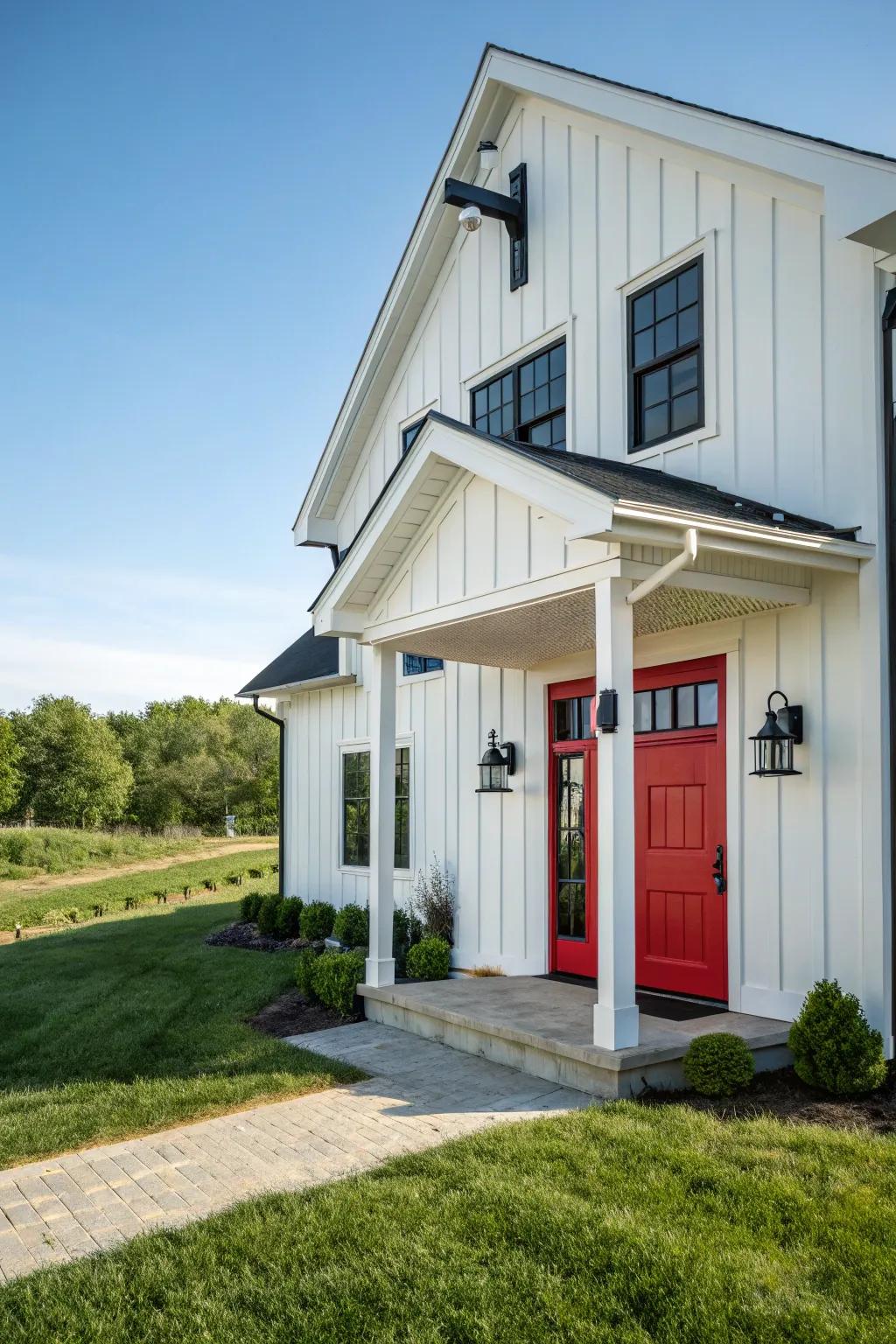 Modern farmhouse featuring a crimson door, blending tradition with modernity.