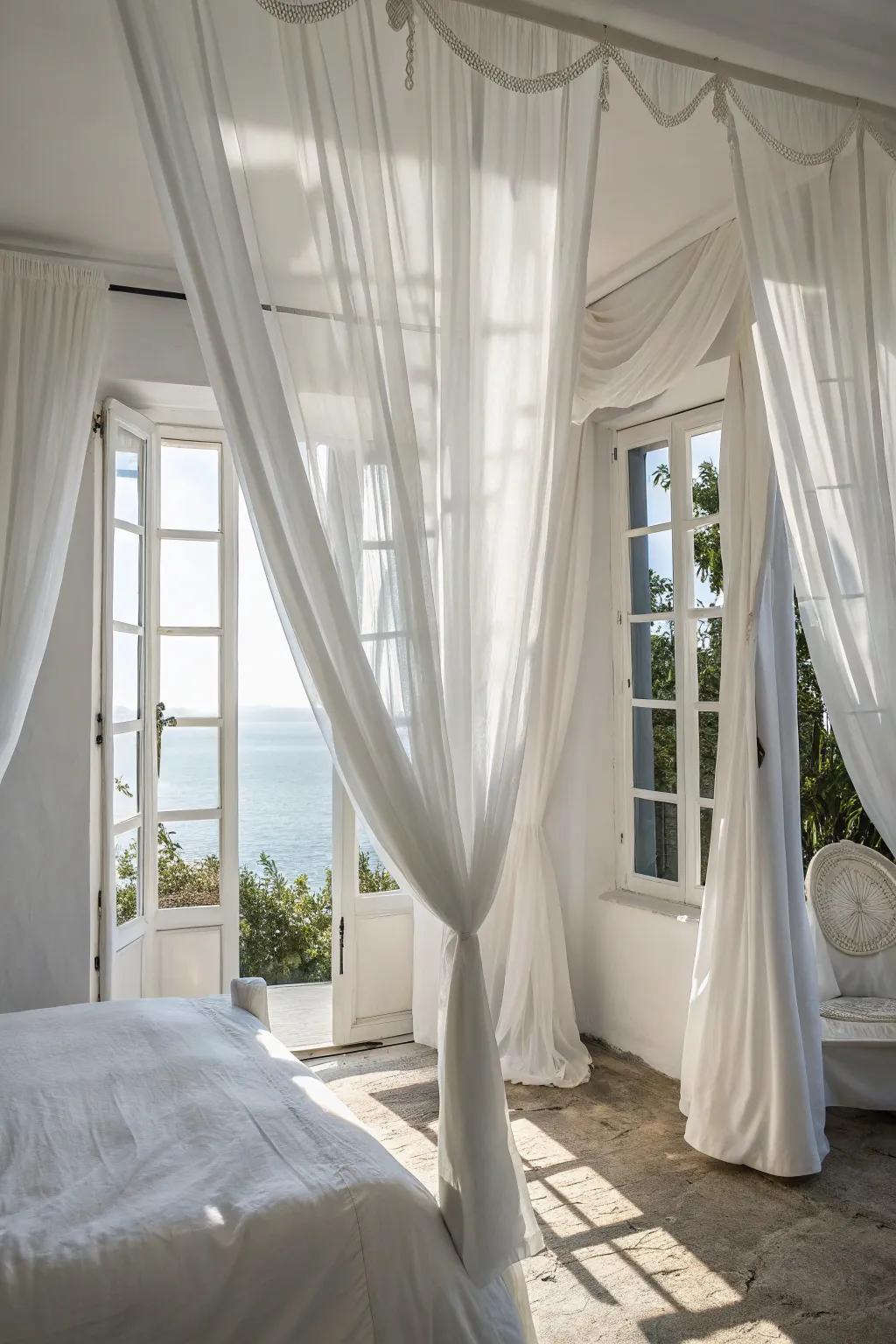 Refined drapes heighten the airy sensation of a white bedroom.