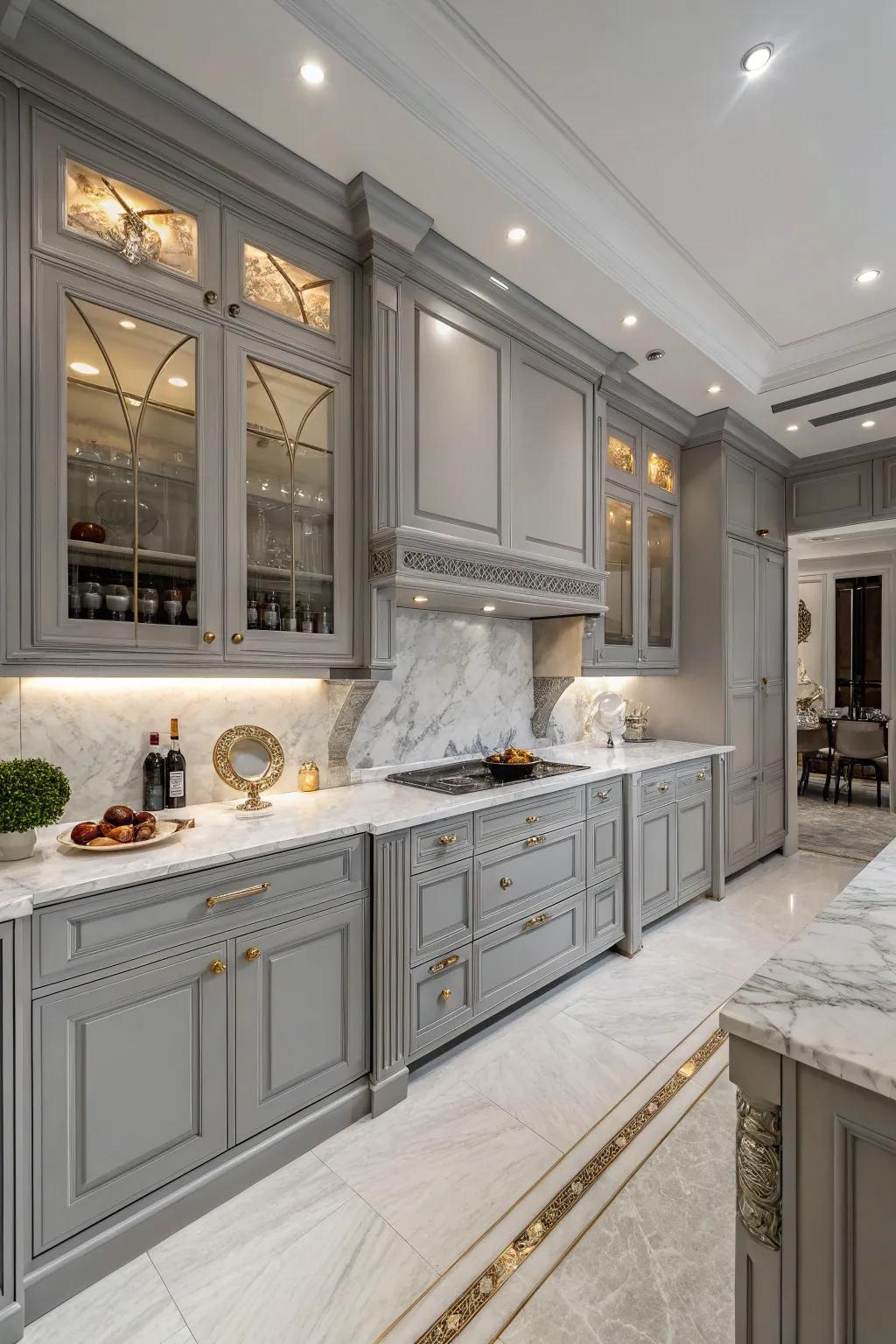 Stone surfaces introduce opulence and refinement to gray cabinets.