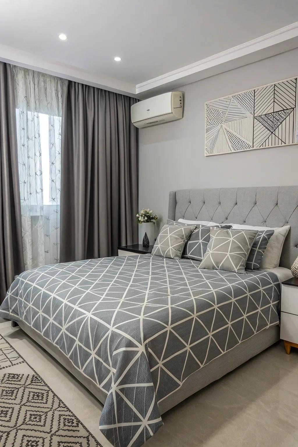 Geometric patterns contribute a modern spin to the grey bedroom.