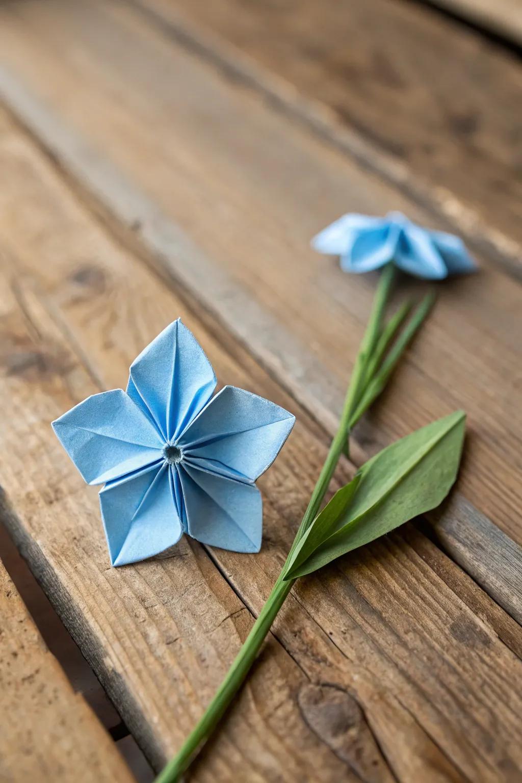 Understated elegance: A handcrafted paper folded forget-me-not, representing the quintessential blend of beauty and simplicity.
