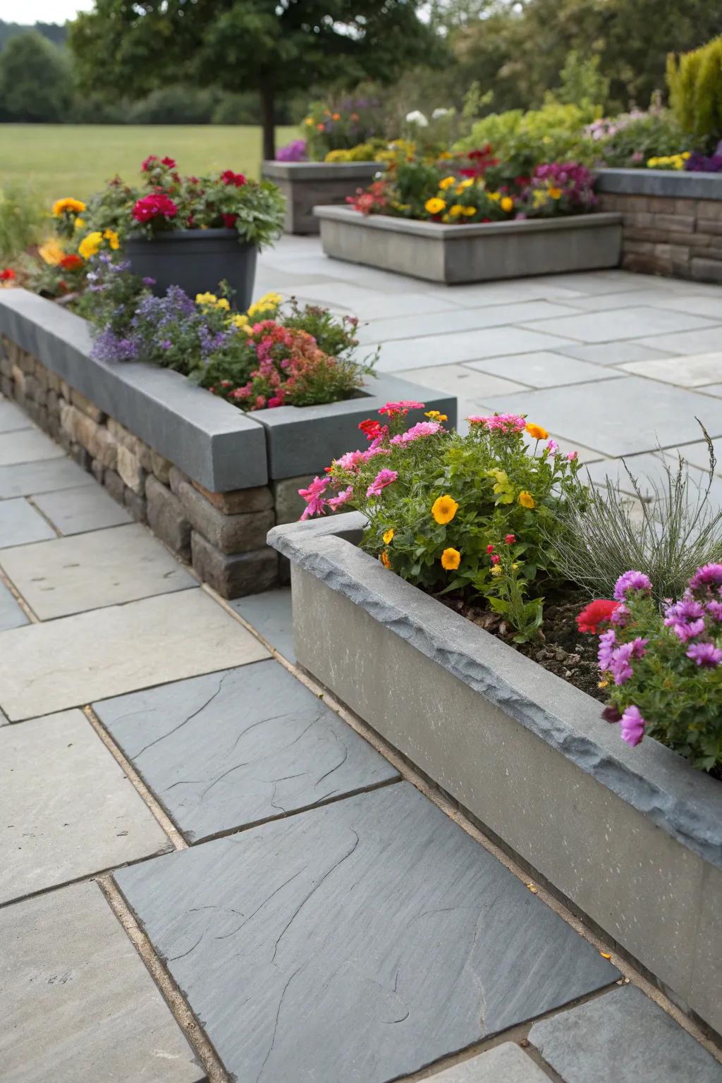 A slate patio complemented by integrated planters for additional greenery.
