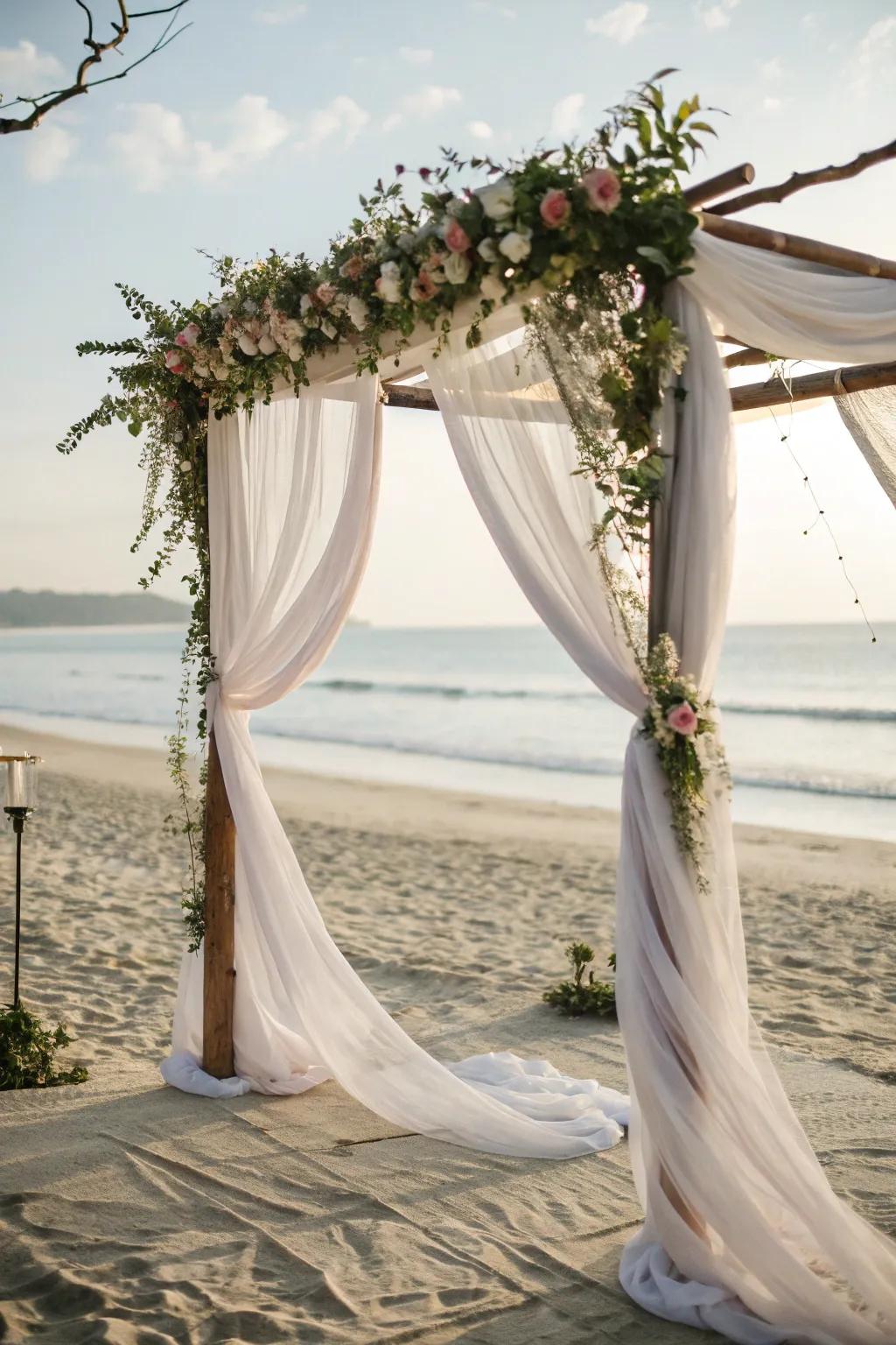 A romantic arch draped with sheer fabric fluttering in the breeze.