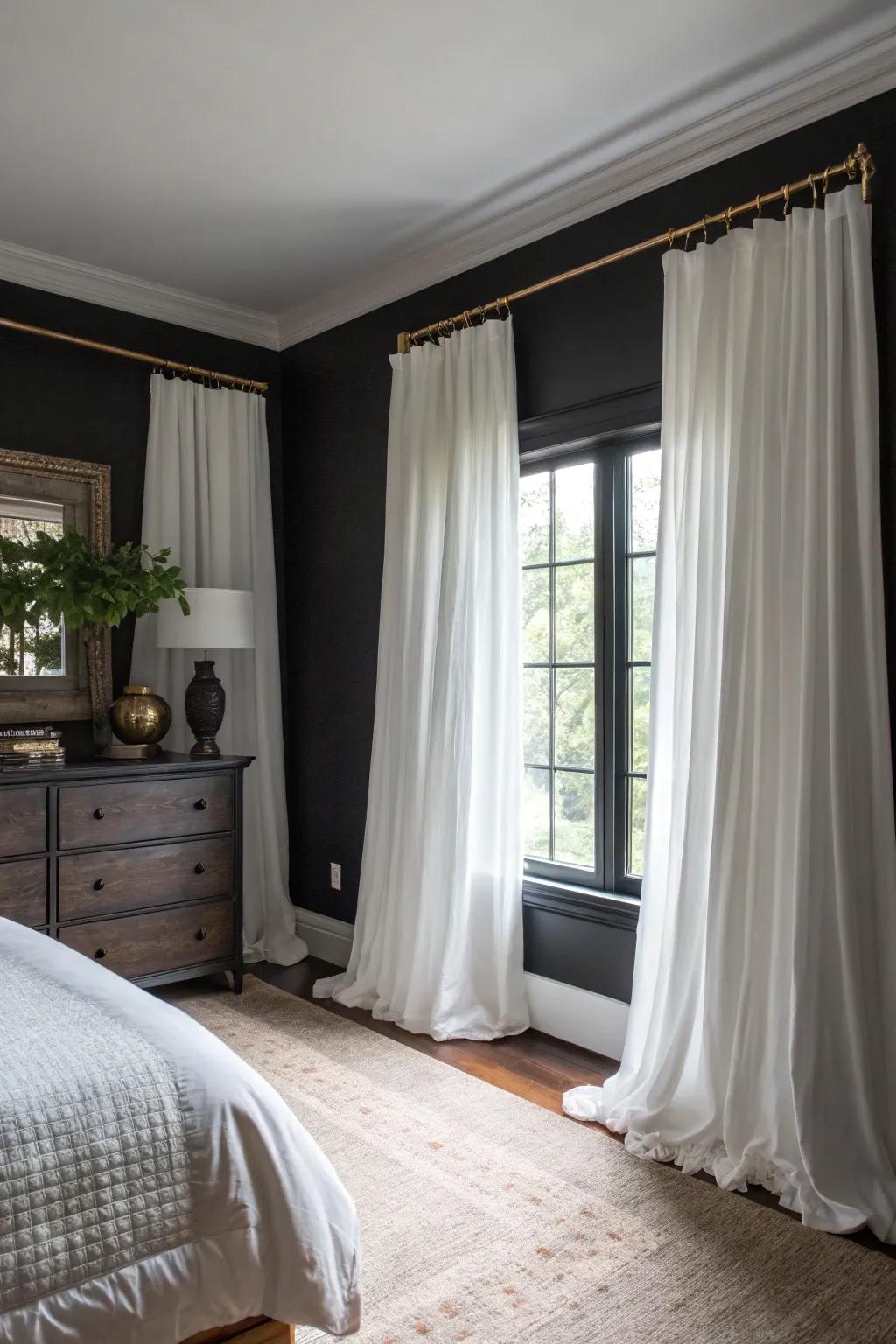 Pale drapes provide a striking contrast to dark elements in the room.
