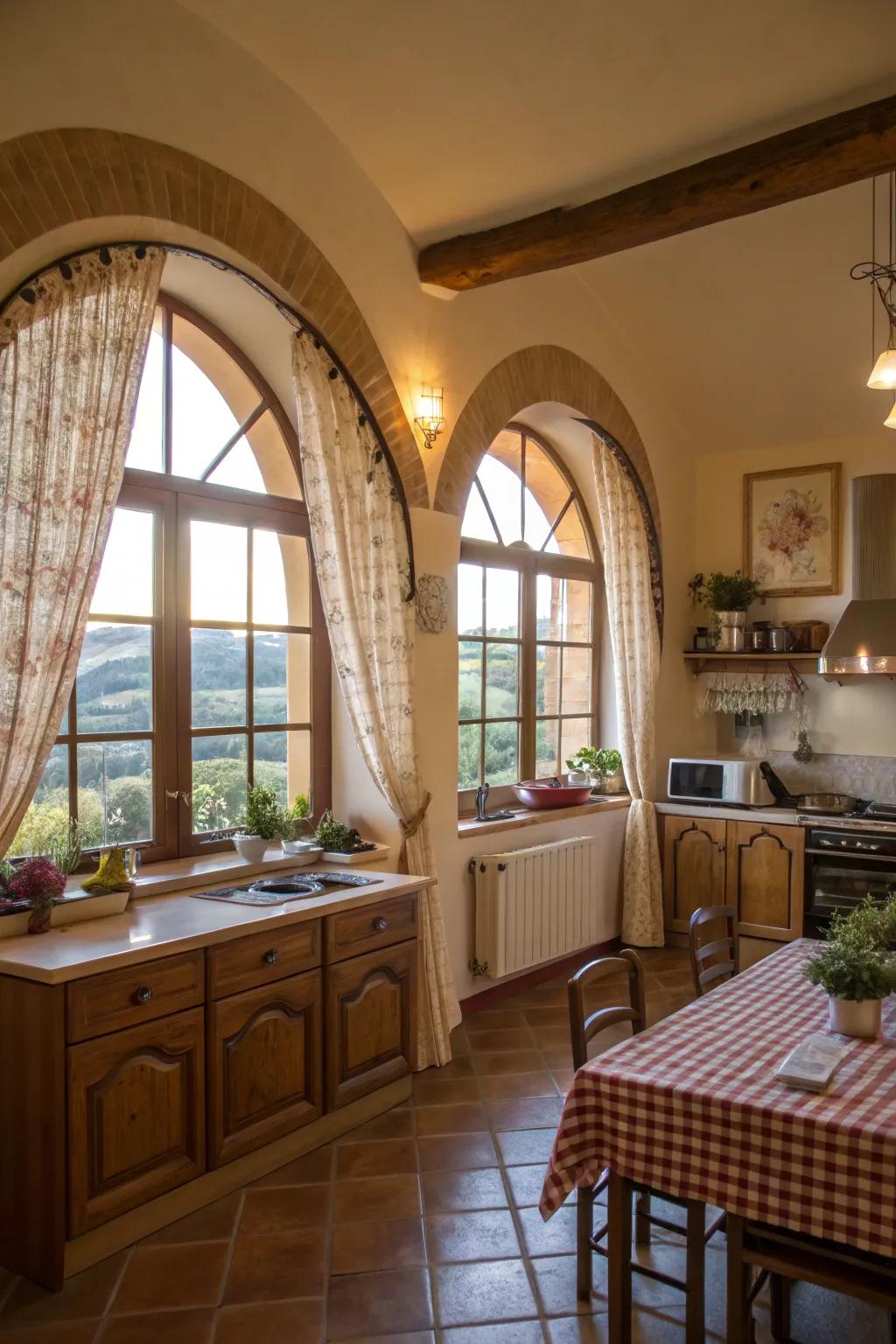 A snug kitchen features bistro-style hangings on arched windows, harmonizing privacy with natural light.