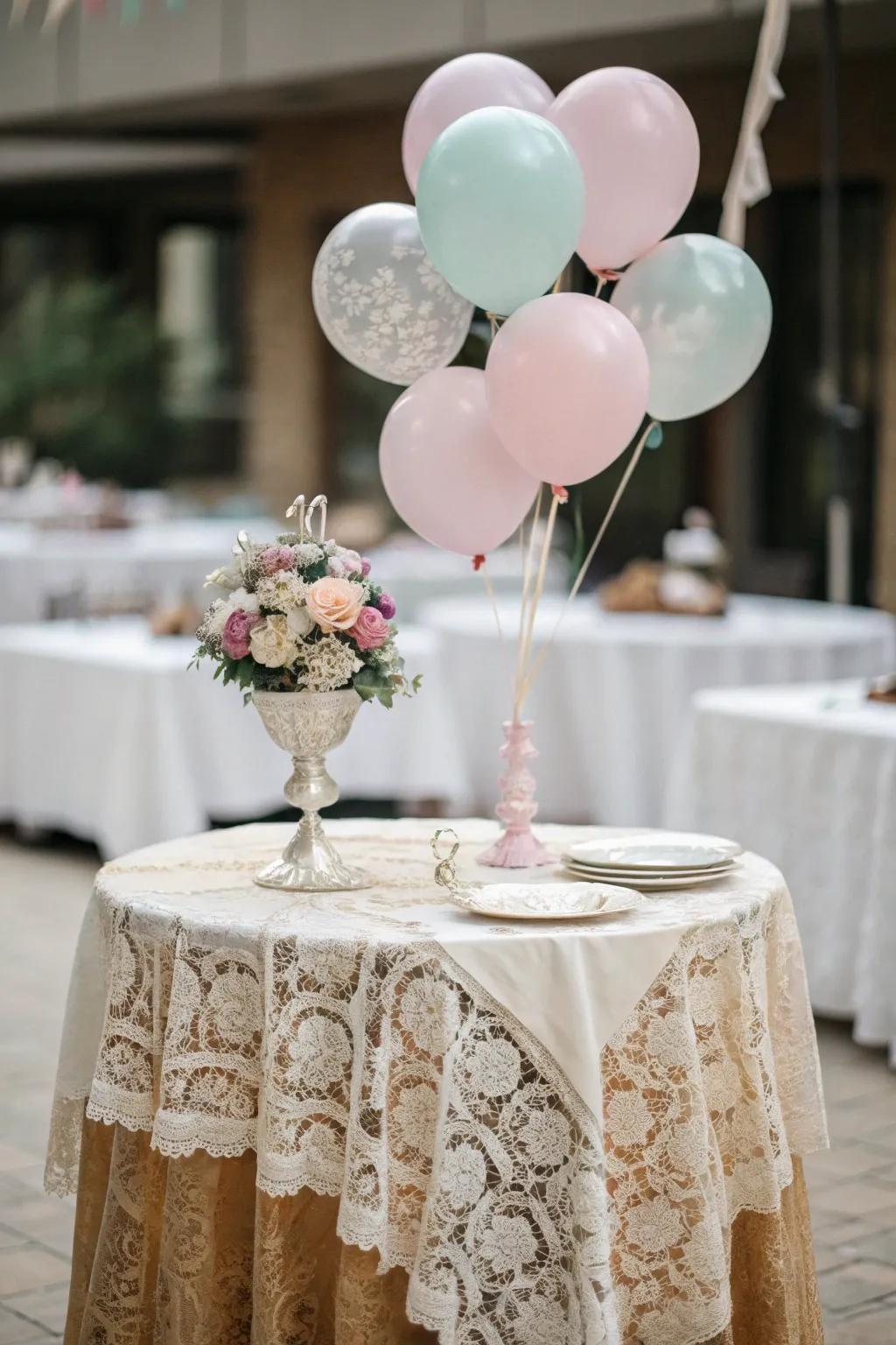 Lace and soft balloons convey vintage grace.