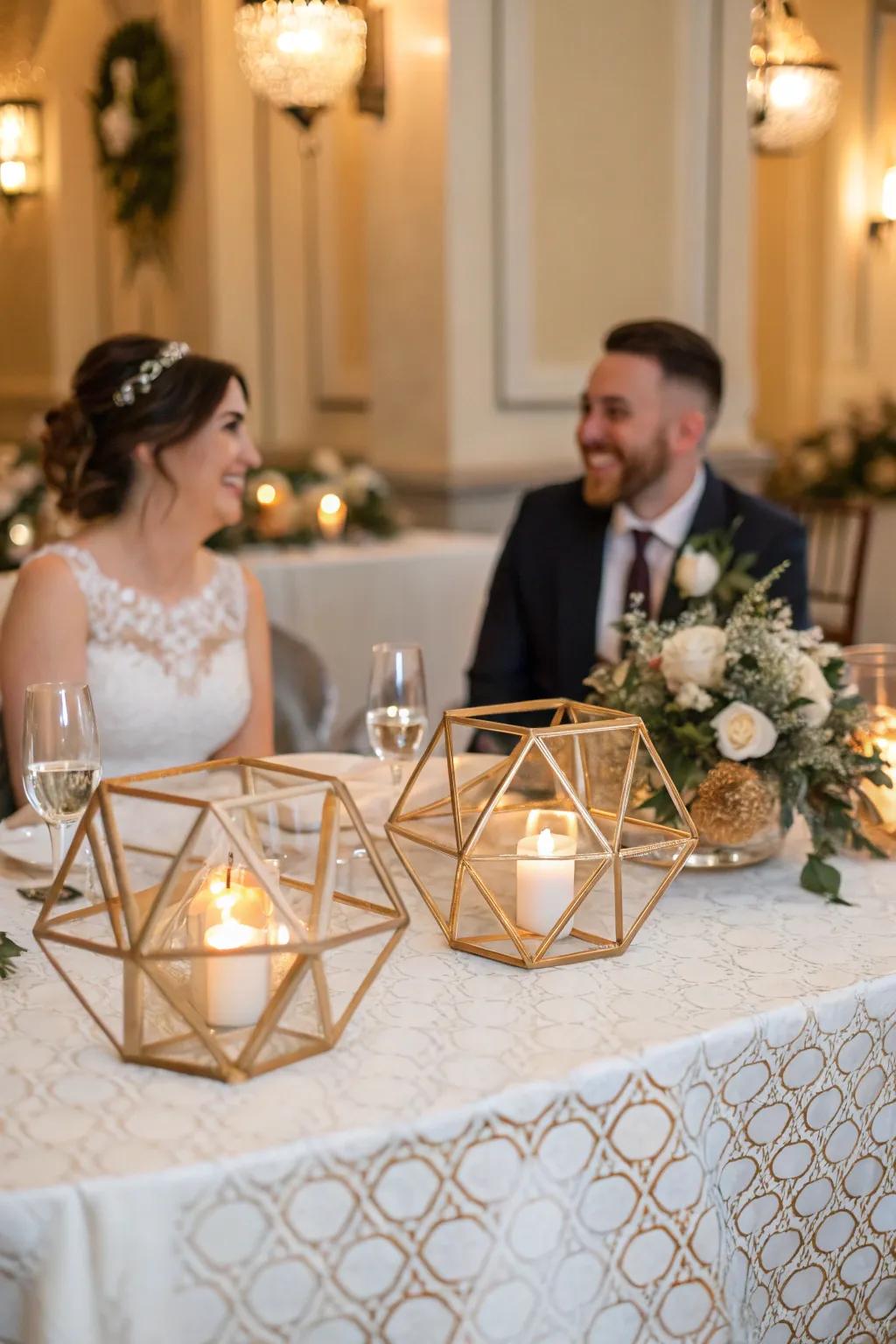 A bride and groom table featuring geometric candle holders.