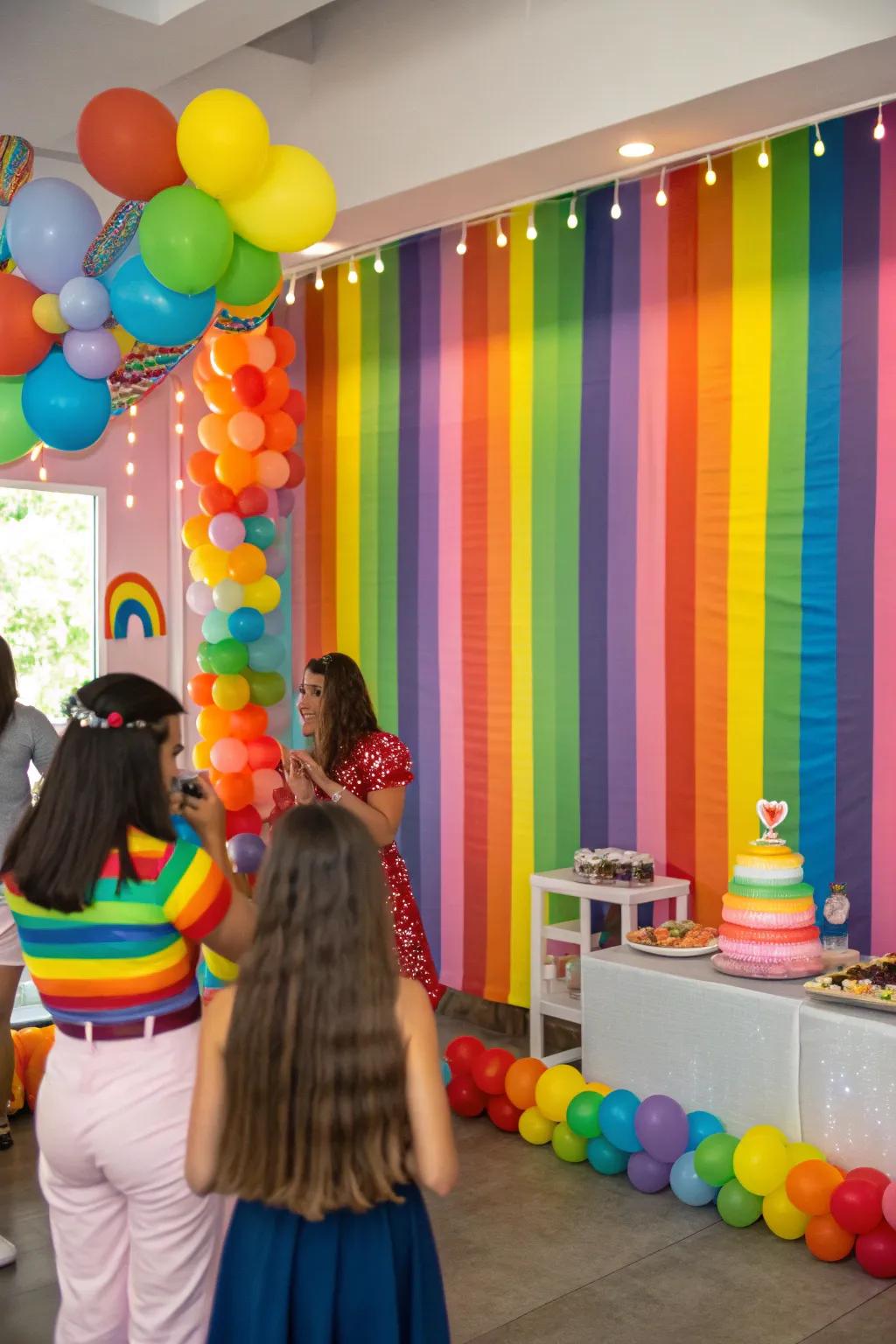 A rainbow-themed backdrop brings a joy-filled setting to the celebration.