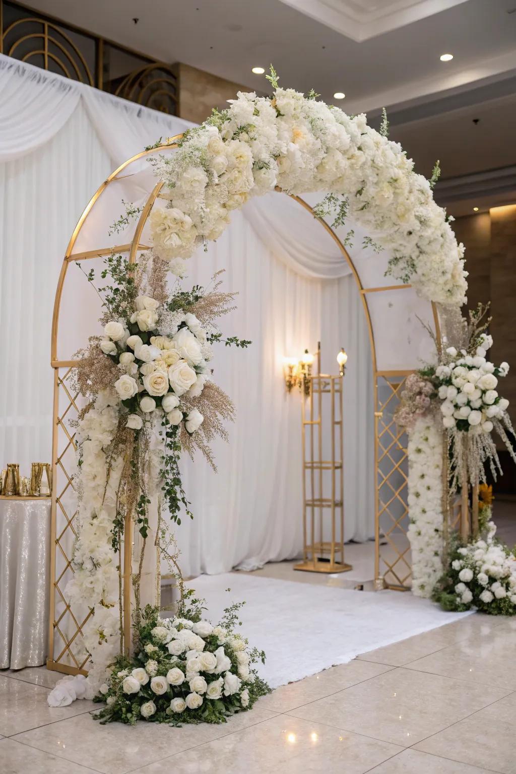 Grand entrance featuring a blossom arch in white and gold.