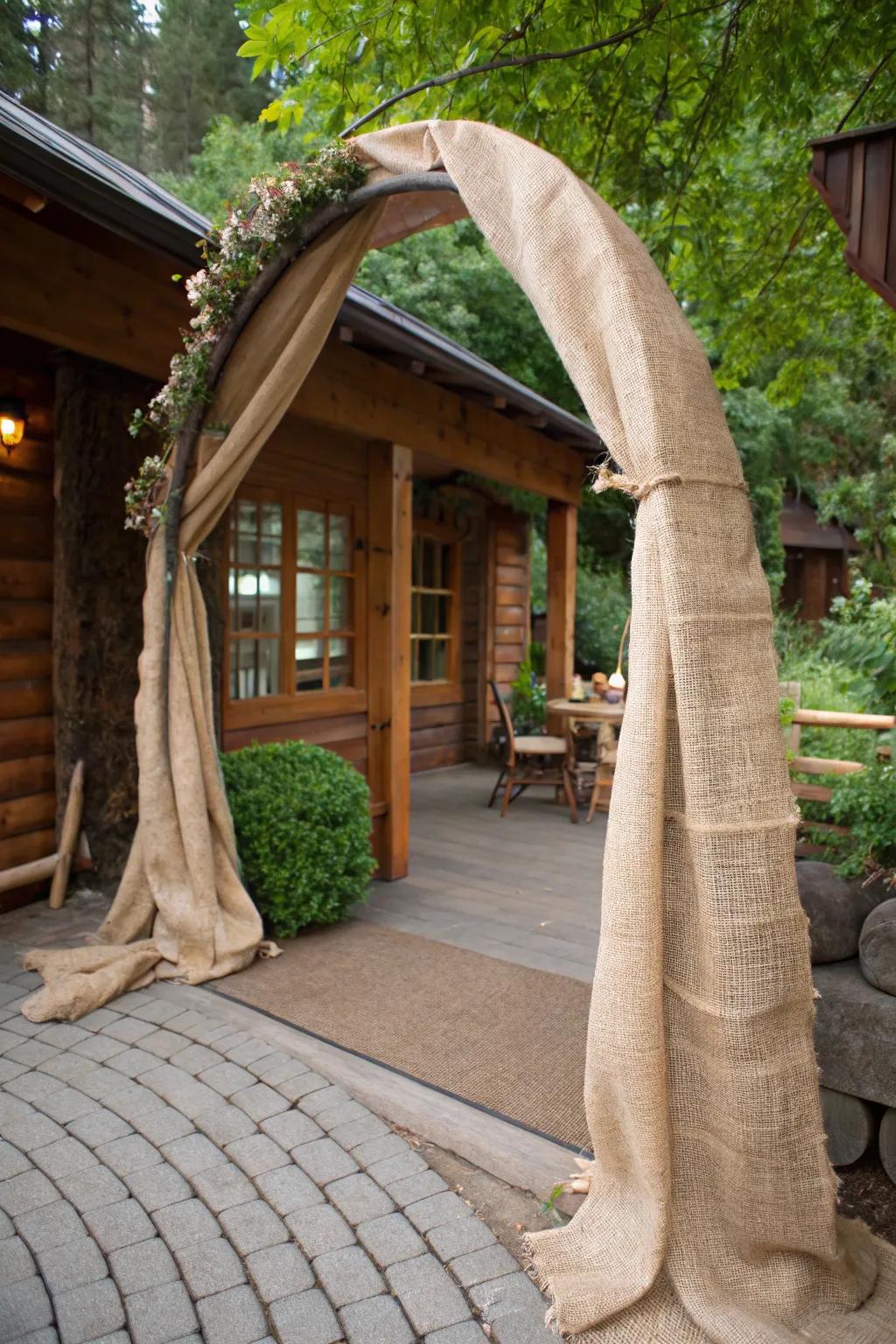 A countryside arch enfolded in hessian for a farmhouse-inspired expression.