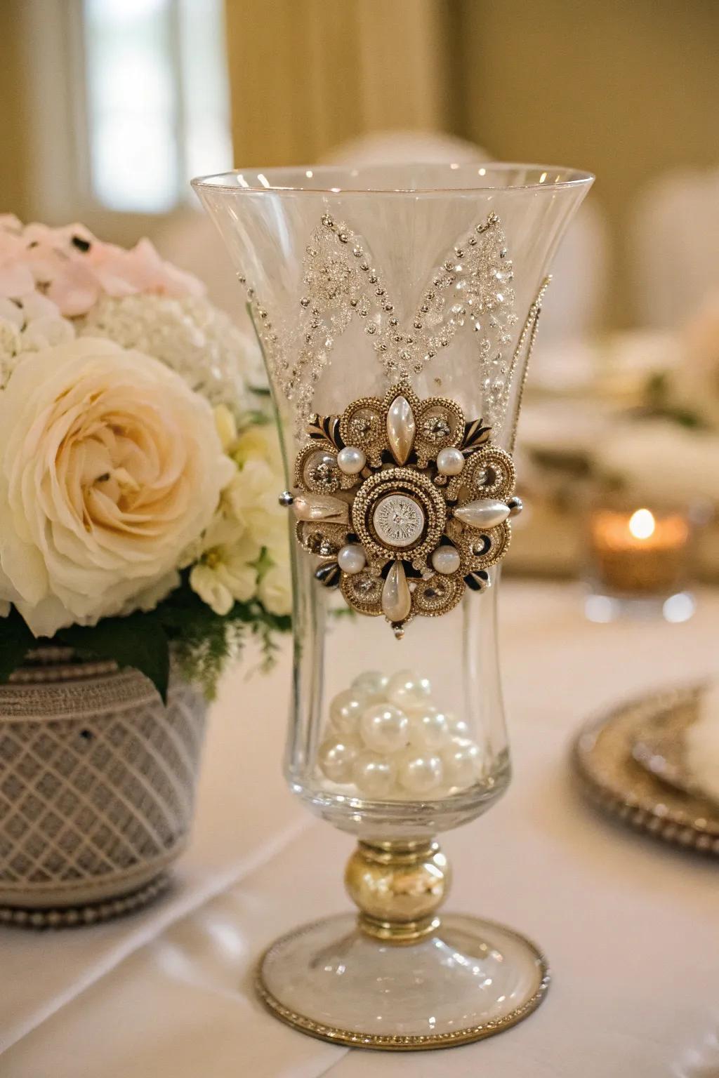 An antique brooch inside a hurricane vase adds a unique vintage touch.