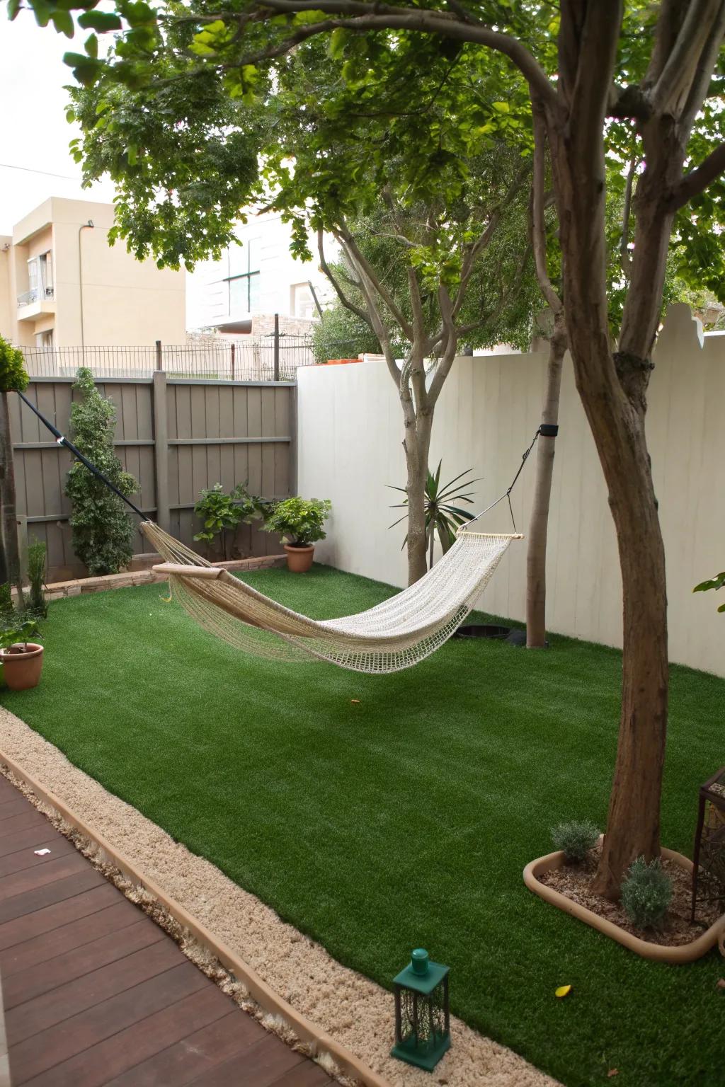 A hanging bed retreat for relaxation atop artificial turf.