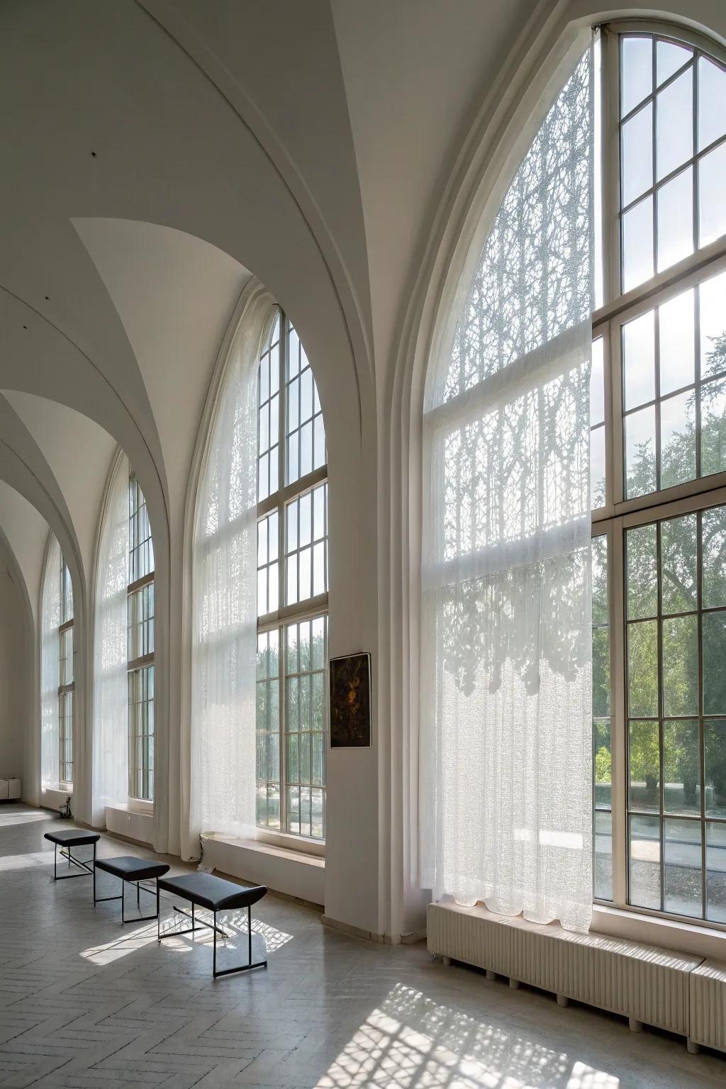 A modern minimalist space utilizes lucent screens on arched windows, achieving privacy without sacrificing light.