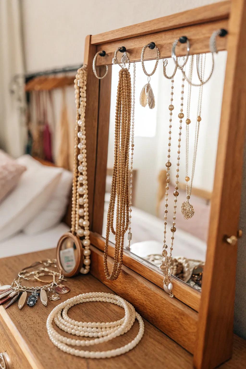 Stylish looking glass equipped with jewelry hooks