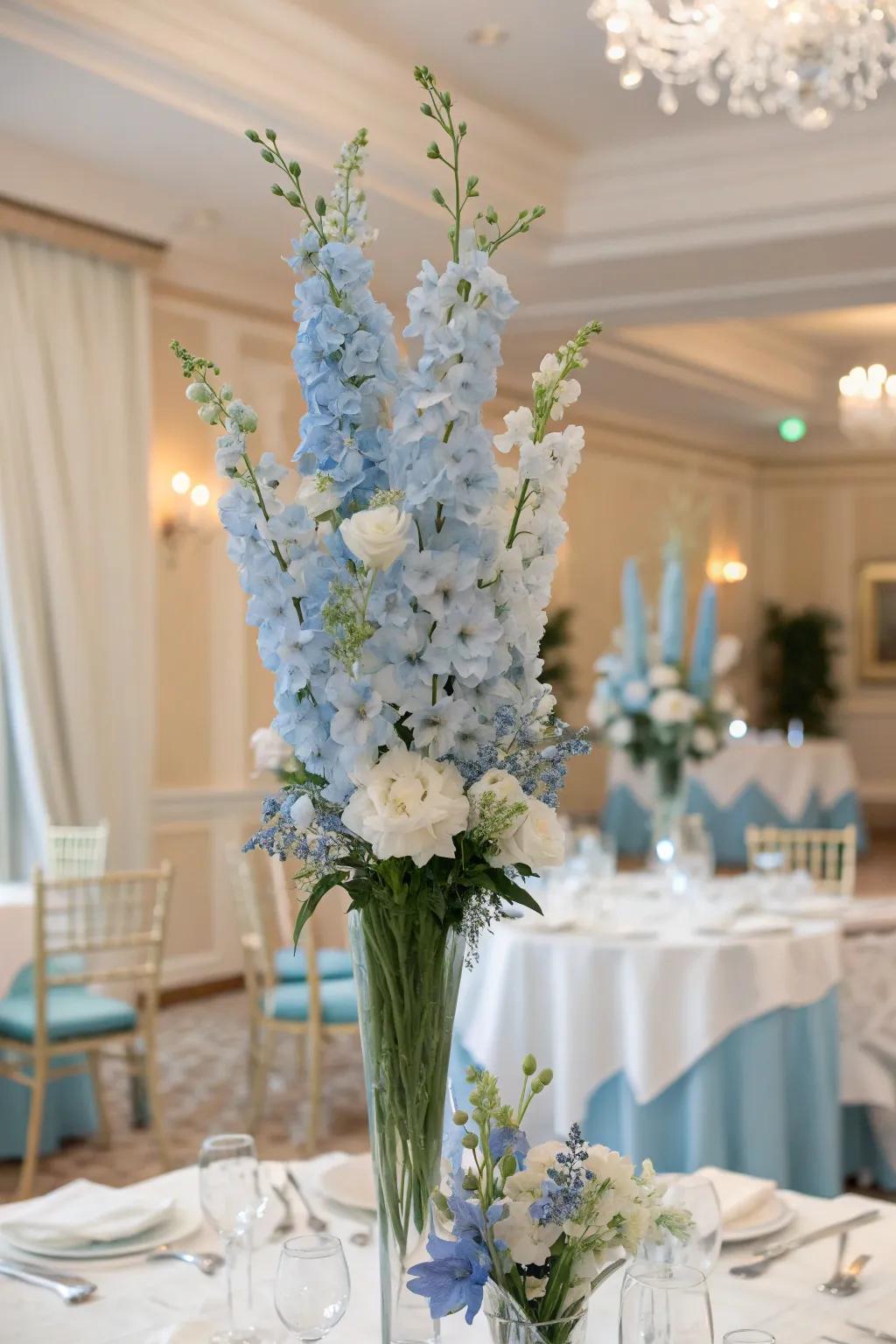 Towering centerpiece displays of soft azure spires establishing an elegant setting.
