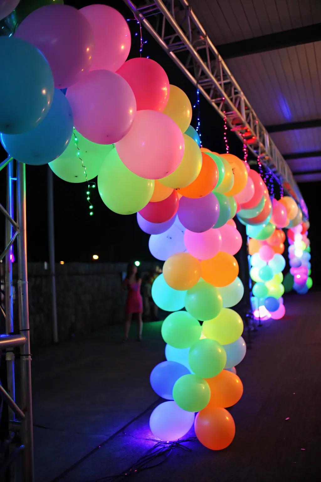 A vibrant neon balloon garland glowing under a blacklight, ideal as a party backdrop.
