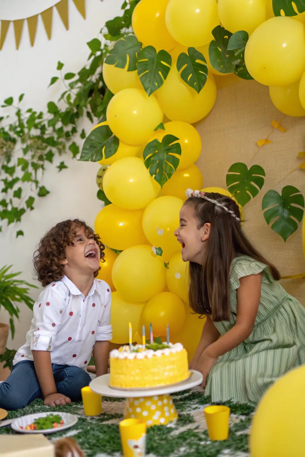 A photo-ready yellow balloon backdrop complemented with greenery.