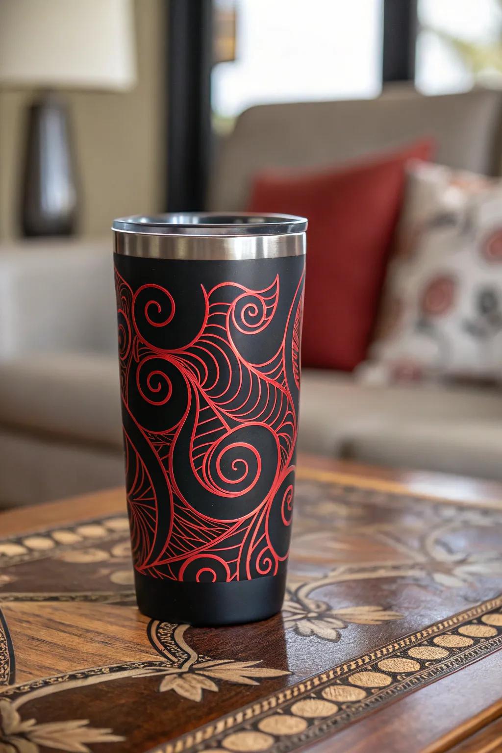Abstract crimson spirals on an onyx tumbler crafting a playful ambiance.