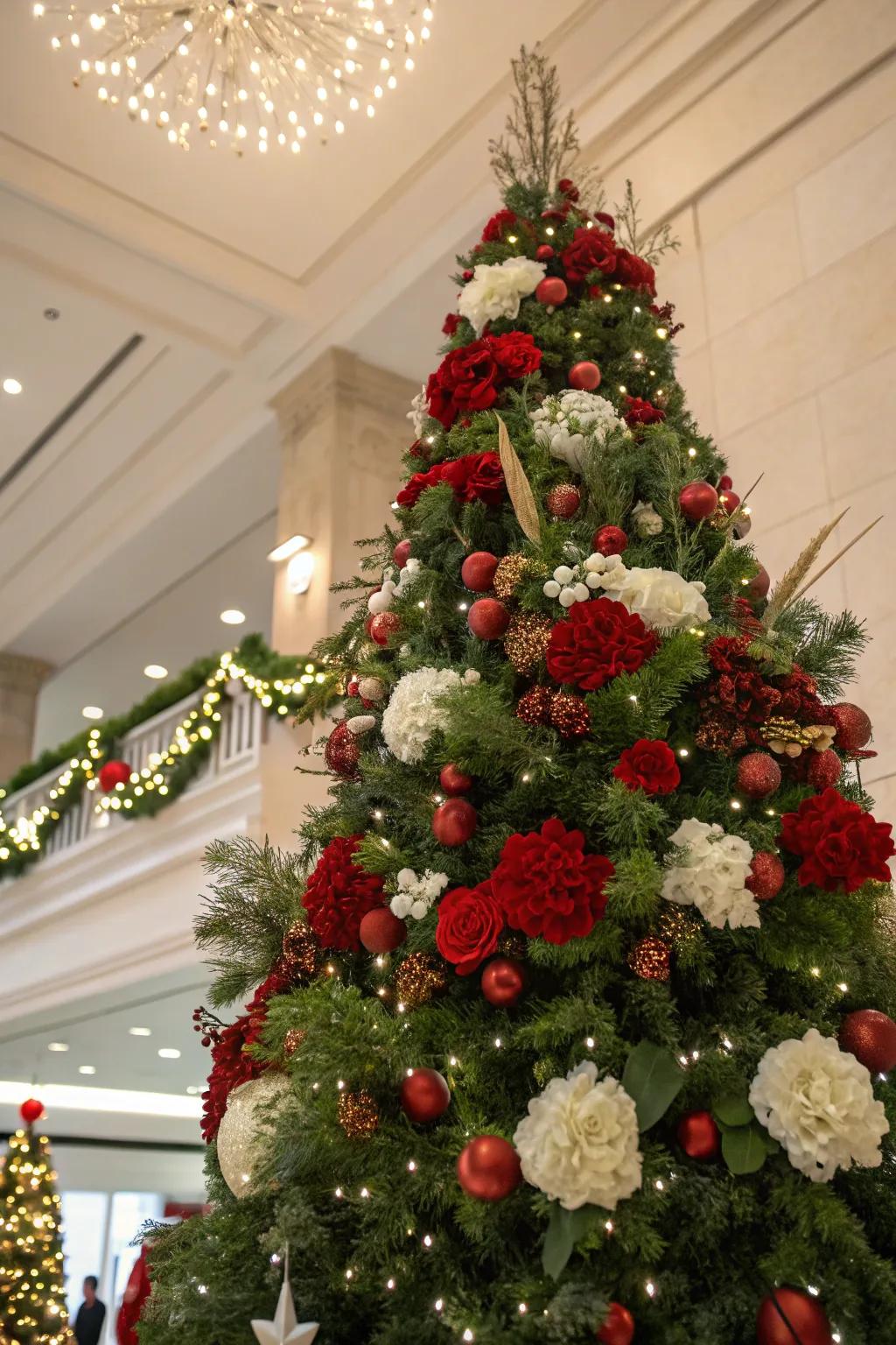 A lush floral arrangement crowns this festive tree beautifully.