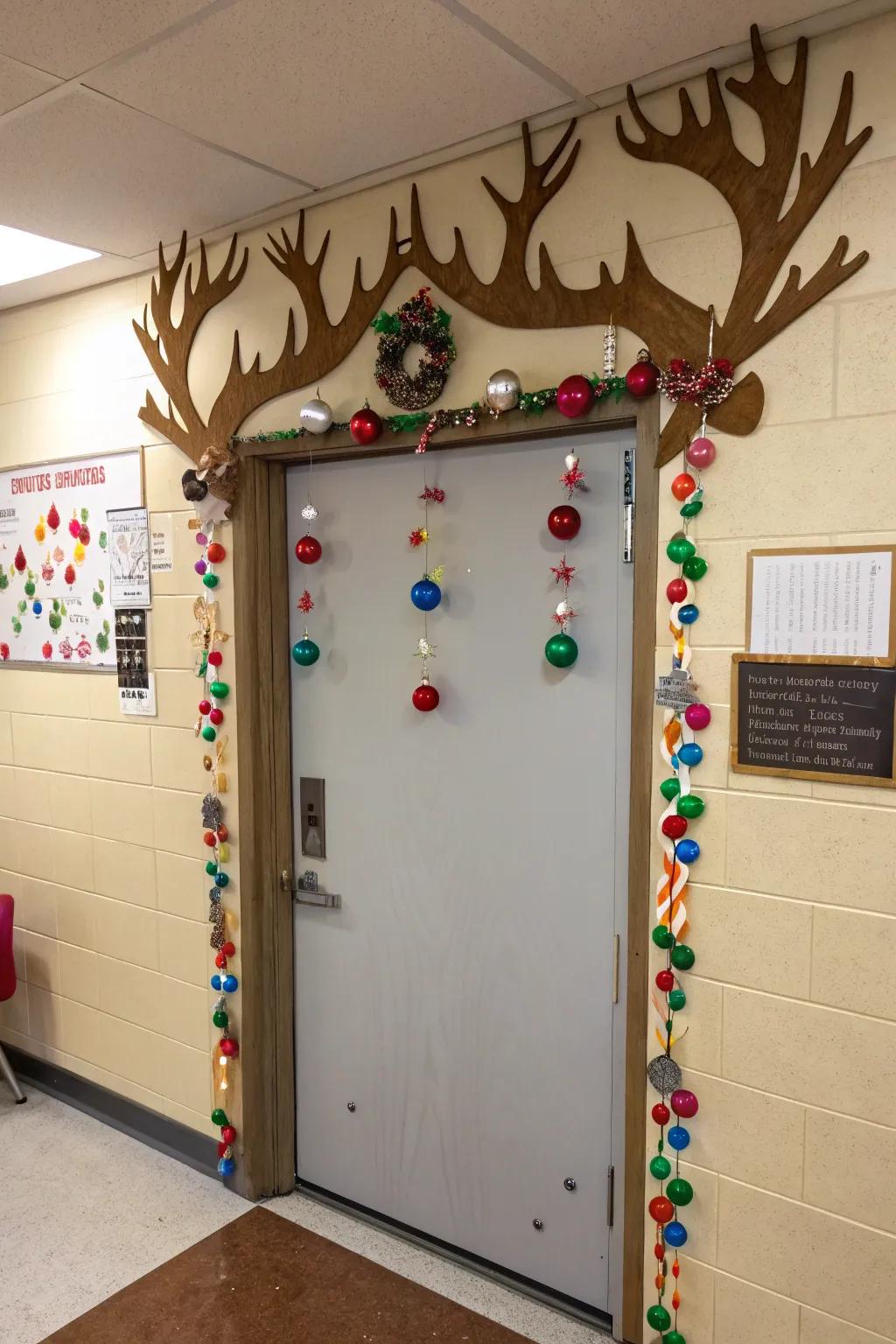 A classroom door featuring giant reindeer antlers, decorated with student-created ornaments.