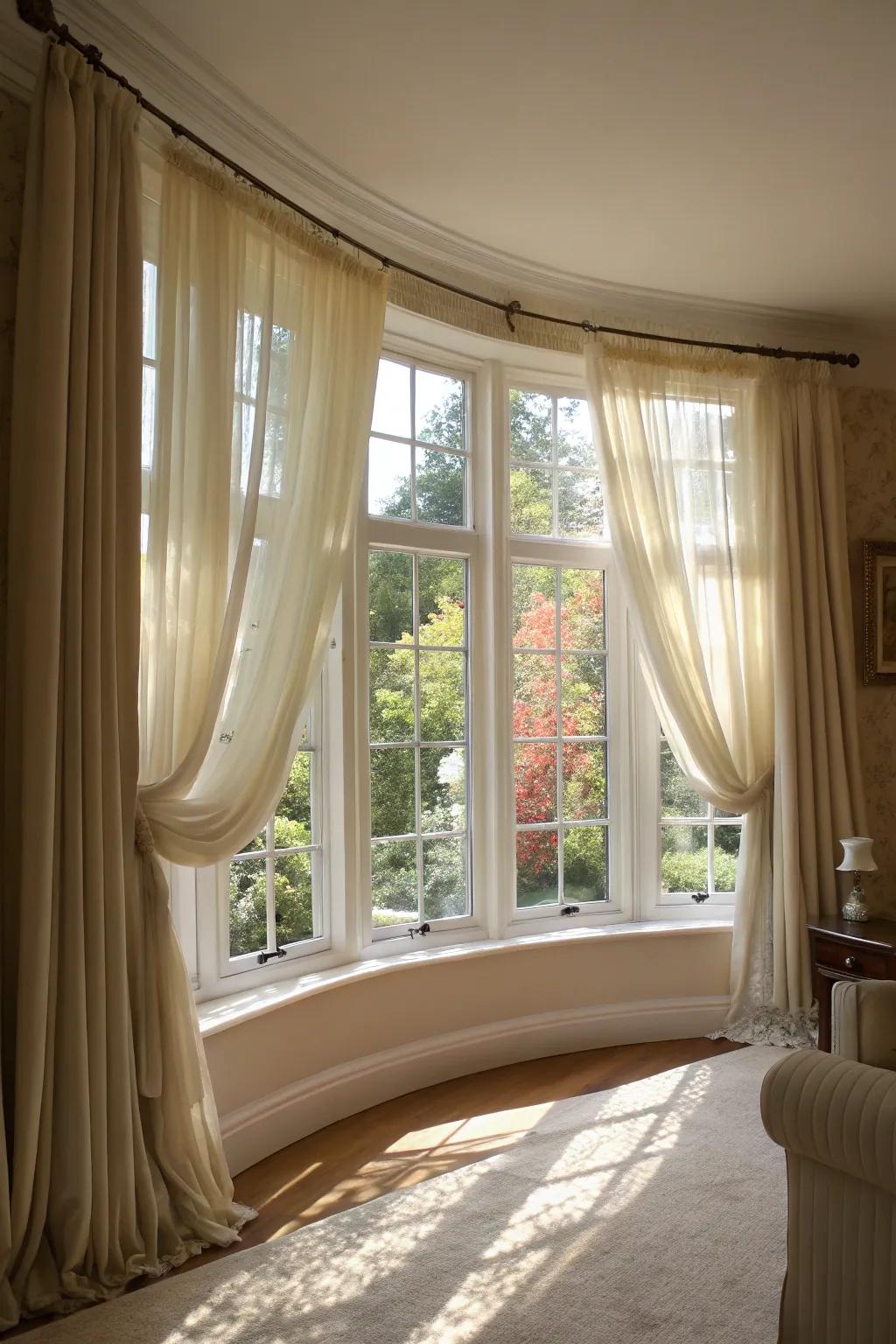 Sheer drapes that enhance the light coming in from a curved bay window.