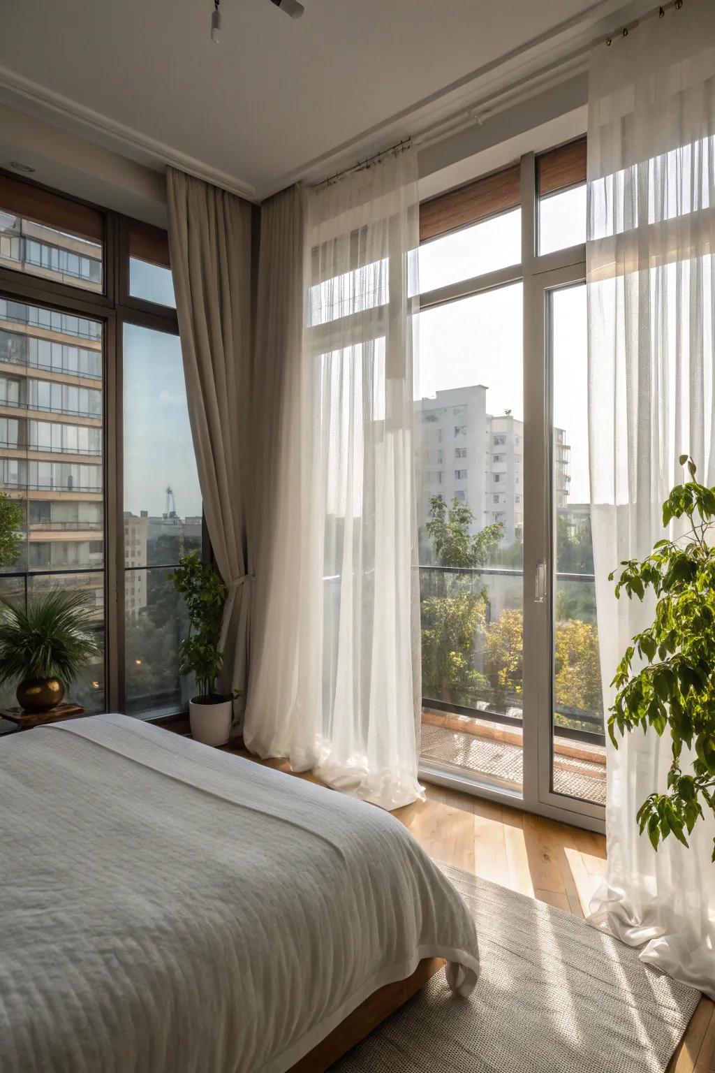 An apartment bedroom that maximizes natural light with large windows and sheer curtains.
