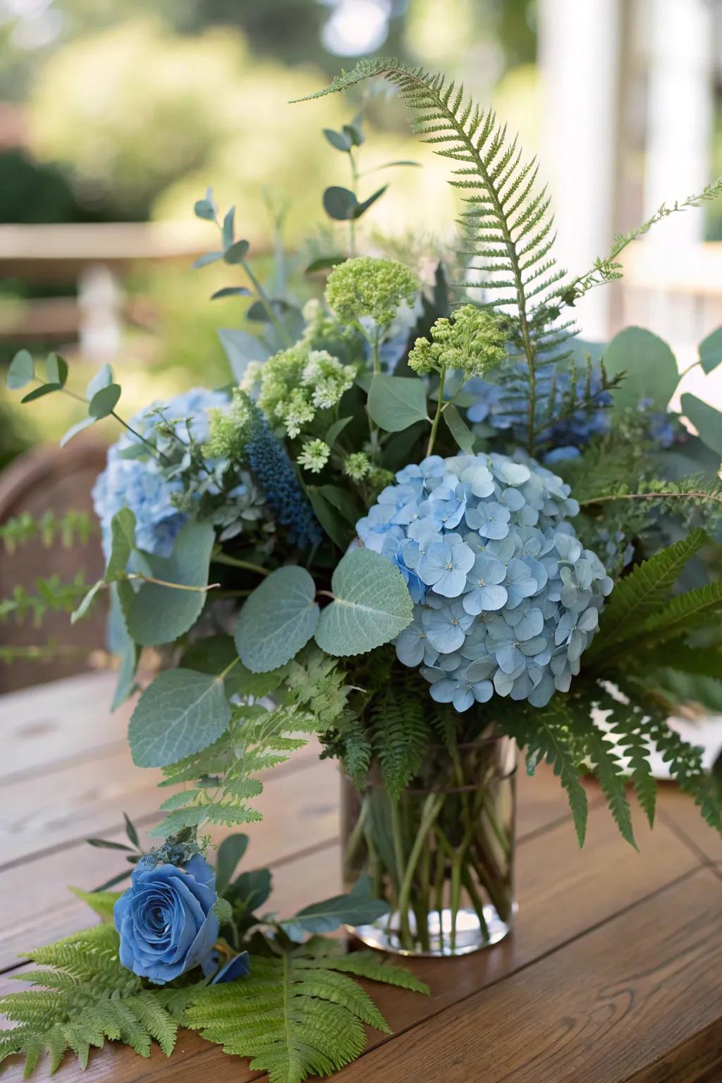 Verdant greenery paired with azure hydrangeas creates a lush visual effect.