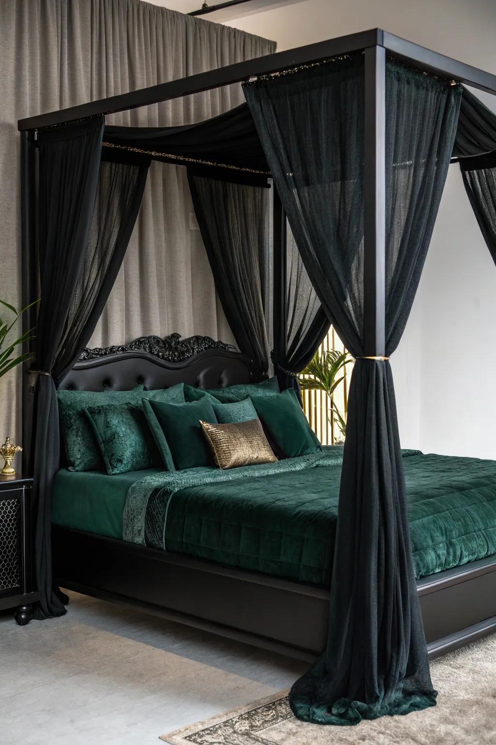 A black canopy bed layered with rich green bedding.