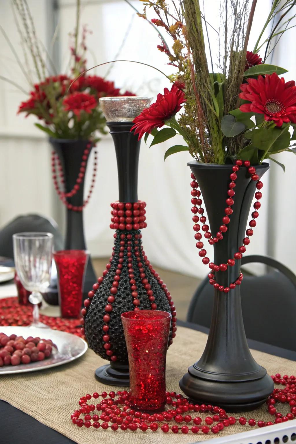A medley of materials, including obsidian ceramic and scarlet beads, generates a tactile centerpiece.