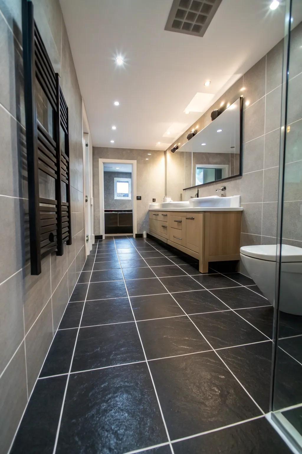 Large black tiles create a seamless and expansive look in this bathroom.