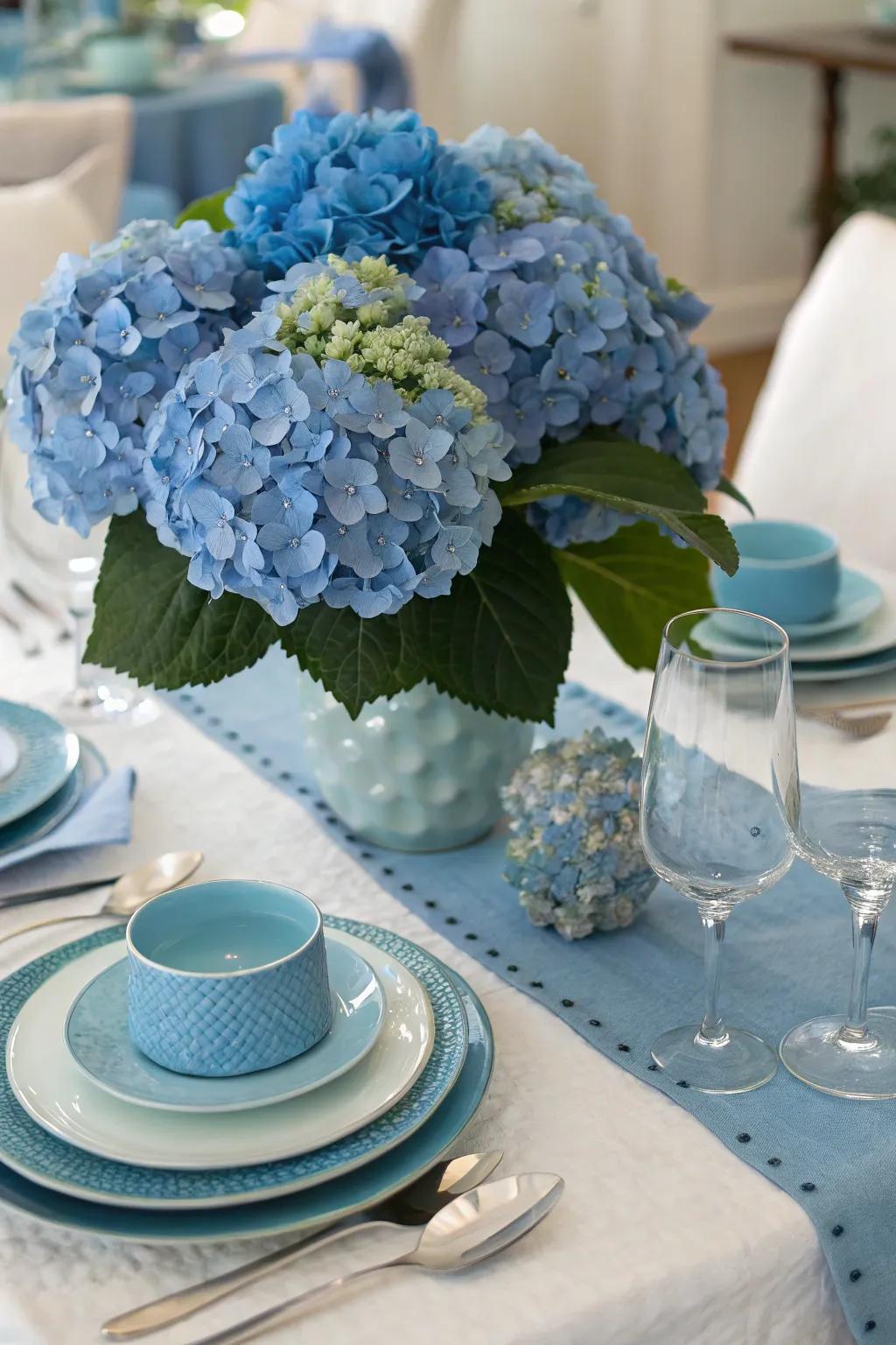 A themed table arrangement complements azure hydrangeas with matching accents.