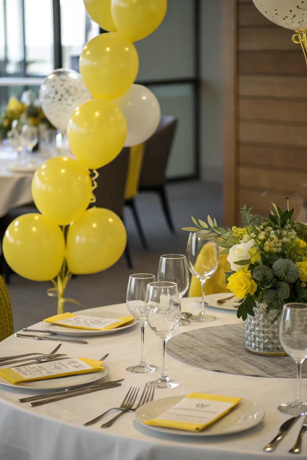 Celebratory tablescape with yellow balloon decor.
