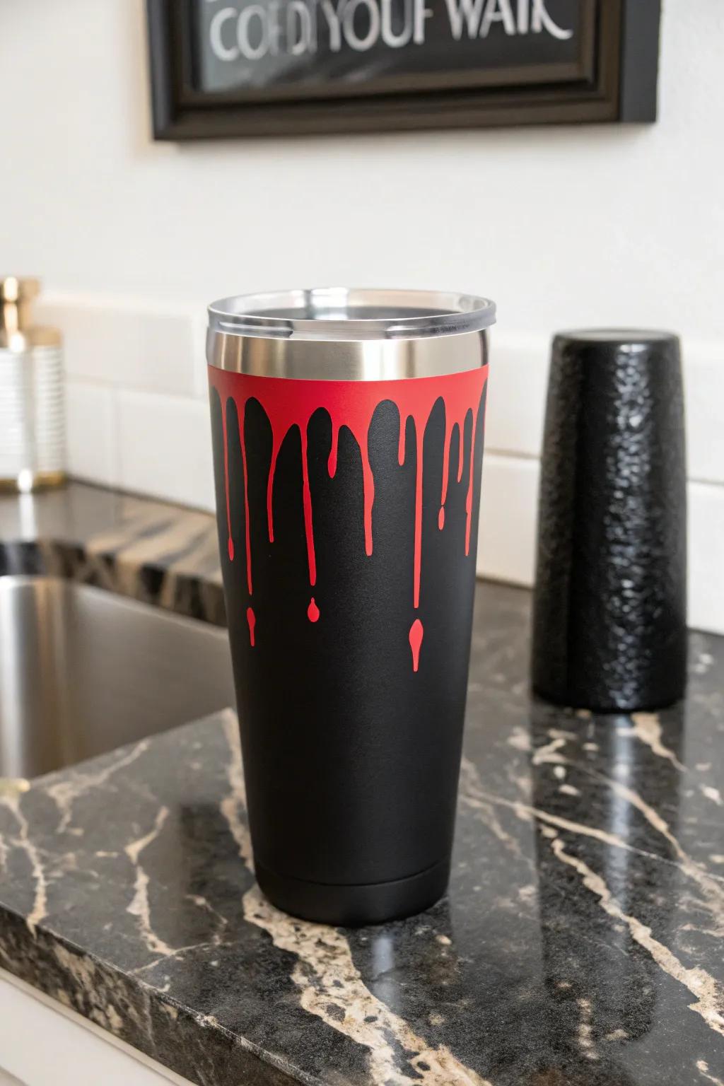 A bold crimson cascade design infusing drama into an onyx tumbler.
