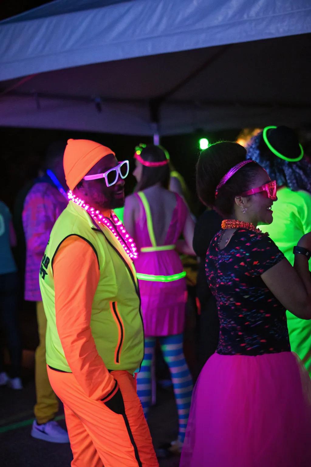 Attendees in neon outfits and extras, glowing and adding vibrancy to the party.