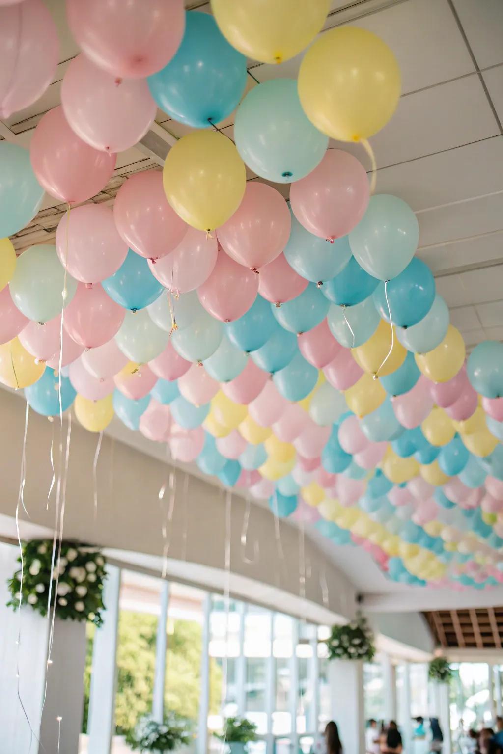 A dreamy pastel balloon canopy transforming a room’s ceiling into a soft, ethereal vista