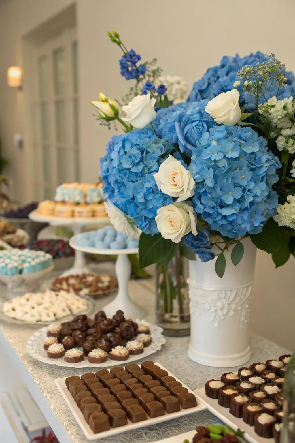 Azure floral displays contributing a crisp, organic feel to the sweet arrangement.